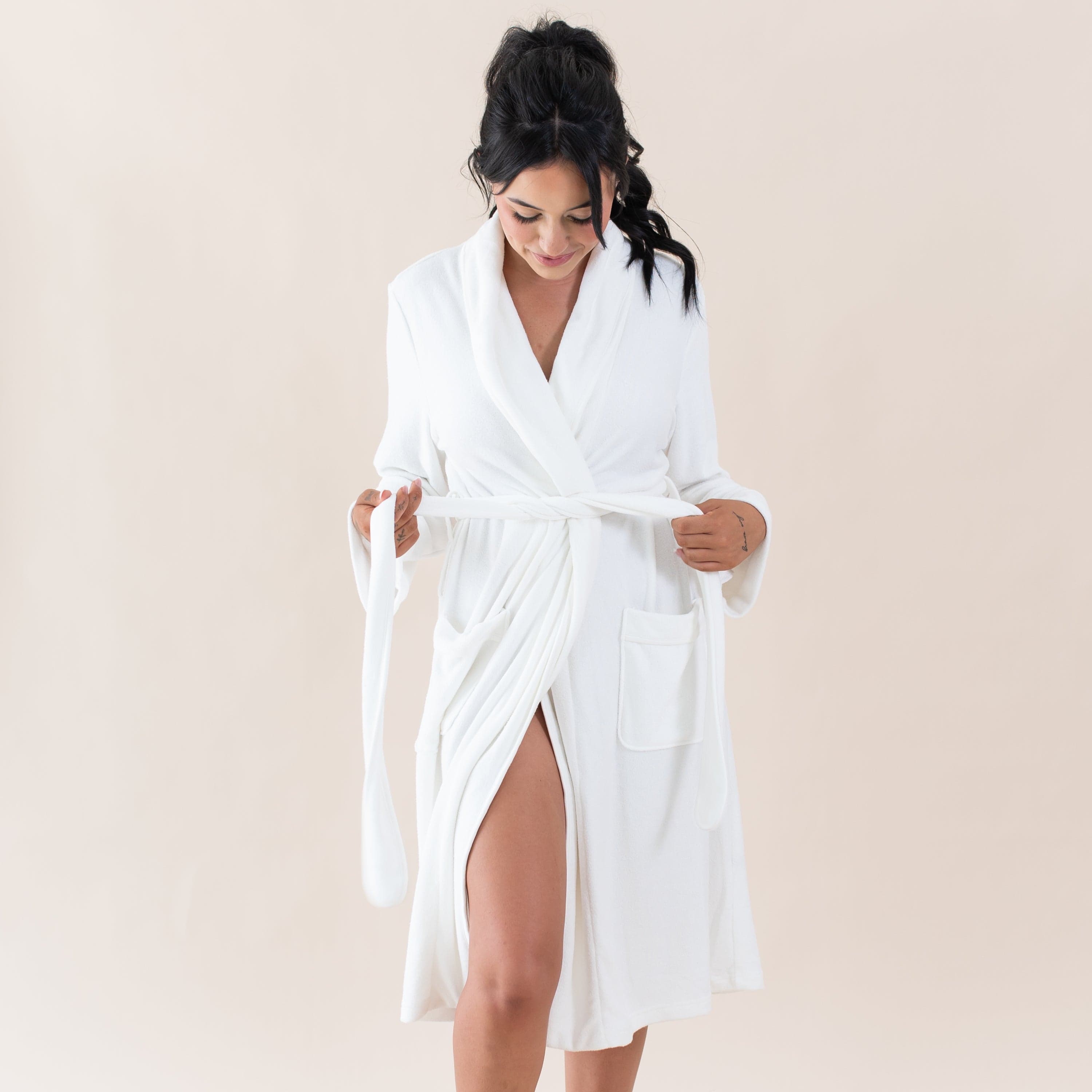 Woman wearing Kyte Baby Adult Robe with self-tie waist in Cloud