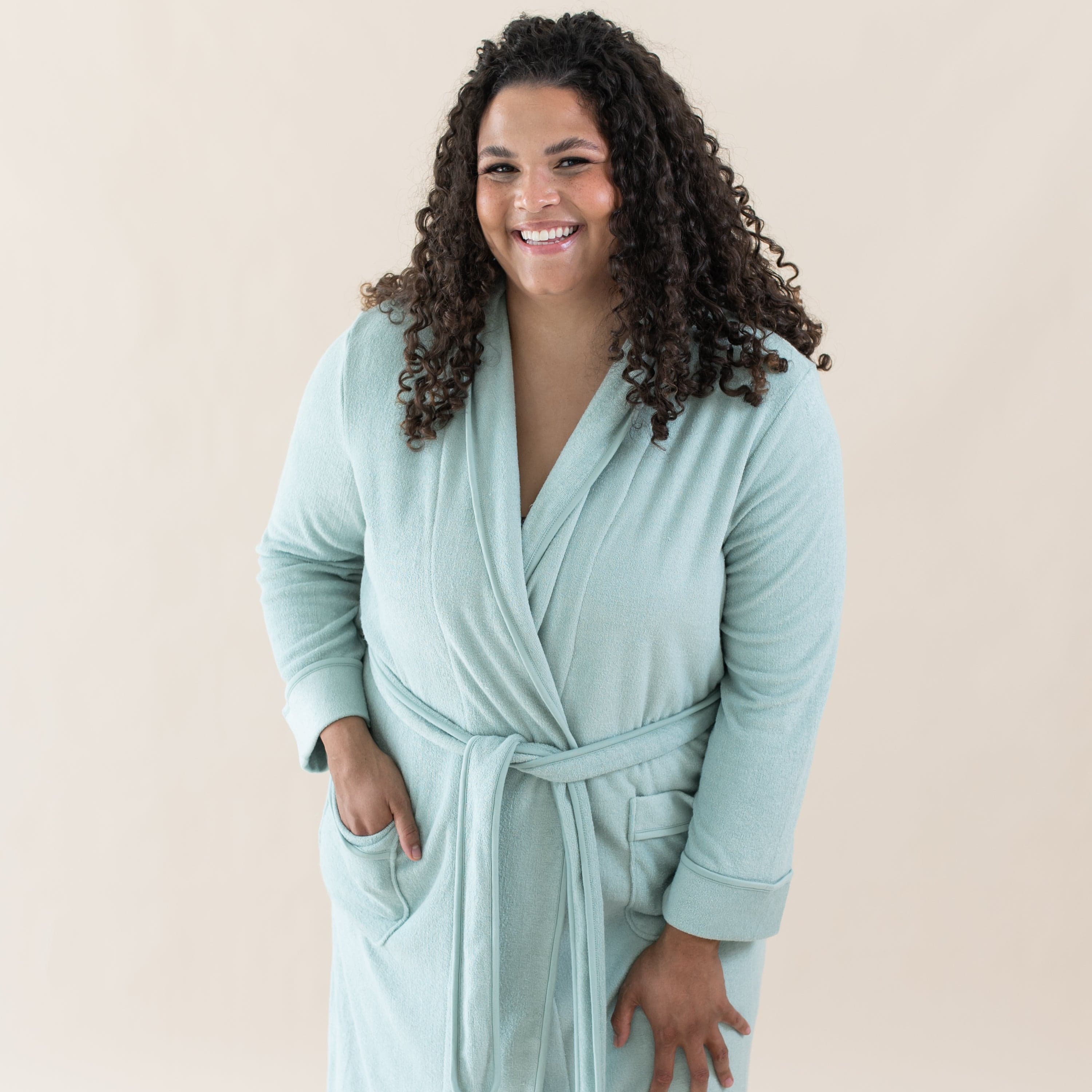 Woman wearing Kyte Baby Bamboo Terry Adult Robe in Sage green