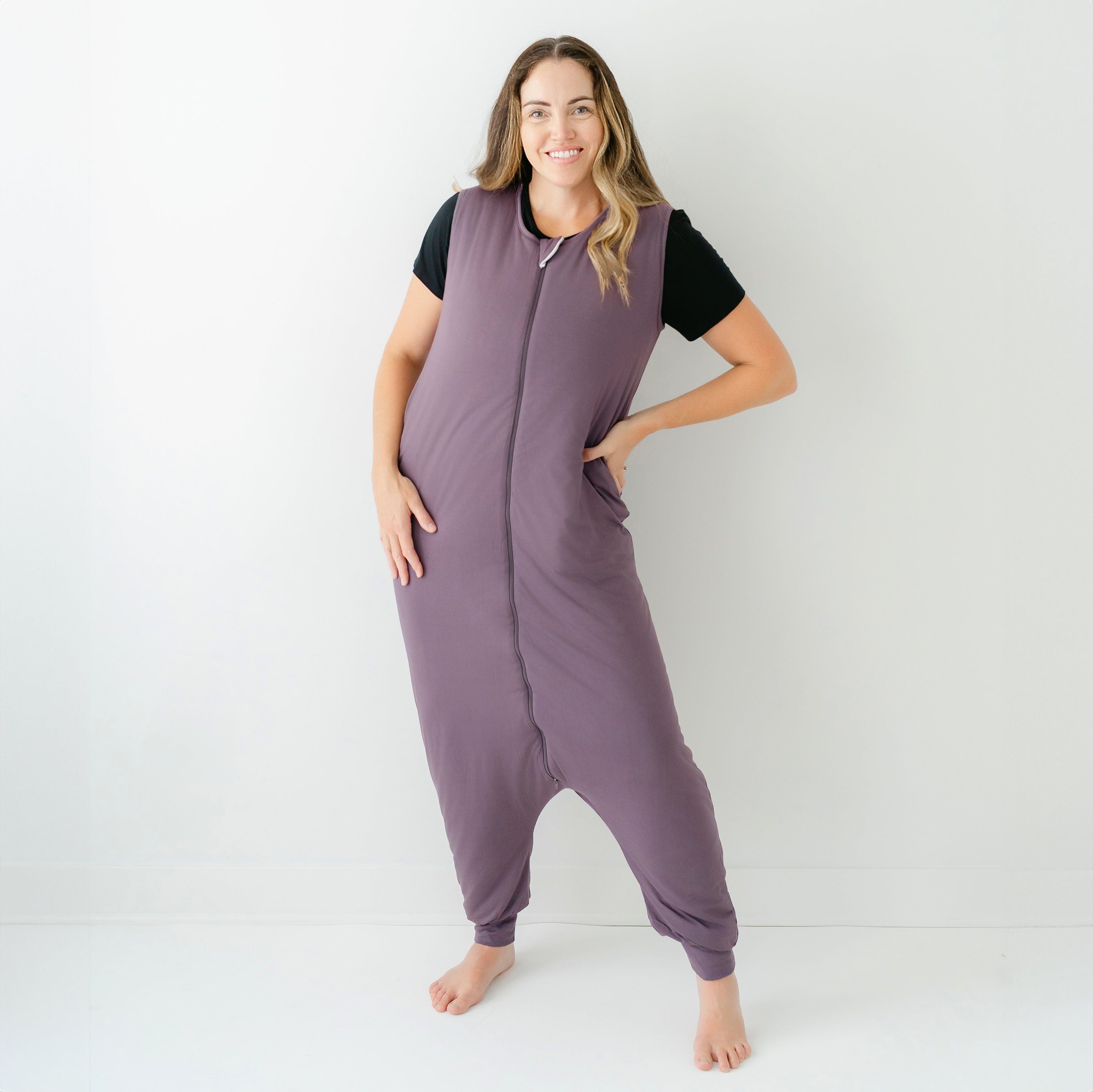 Woman wearing Kyte Baby Adult Sleep Bag Walker in Currant