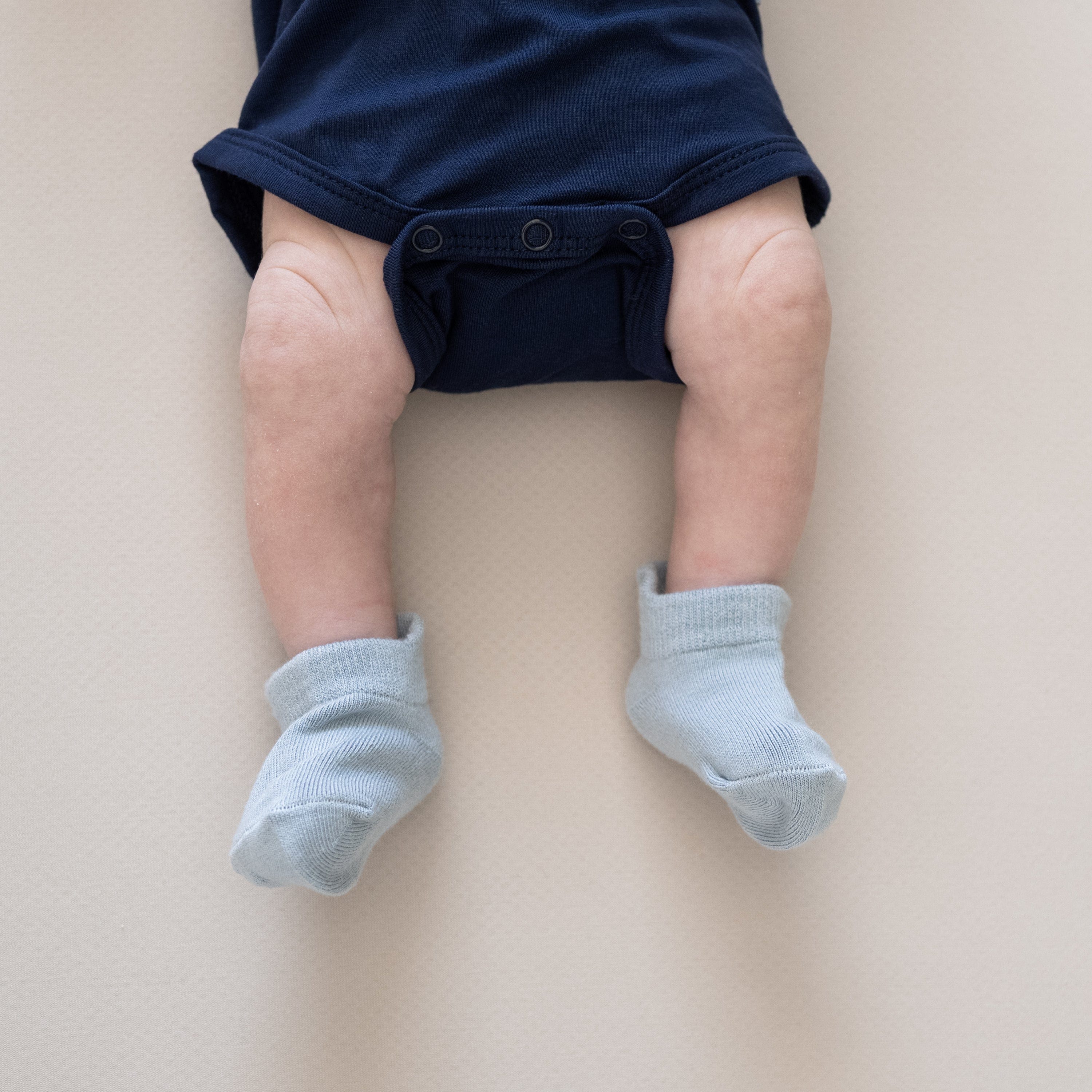 Infant wearing Kyte Baby Ankle Socks in Cool Light Blue