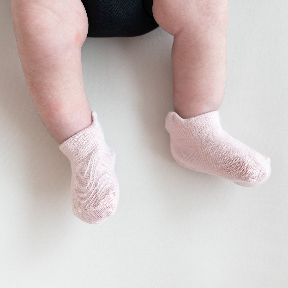 Baby wearing pink ankle socks