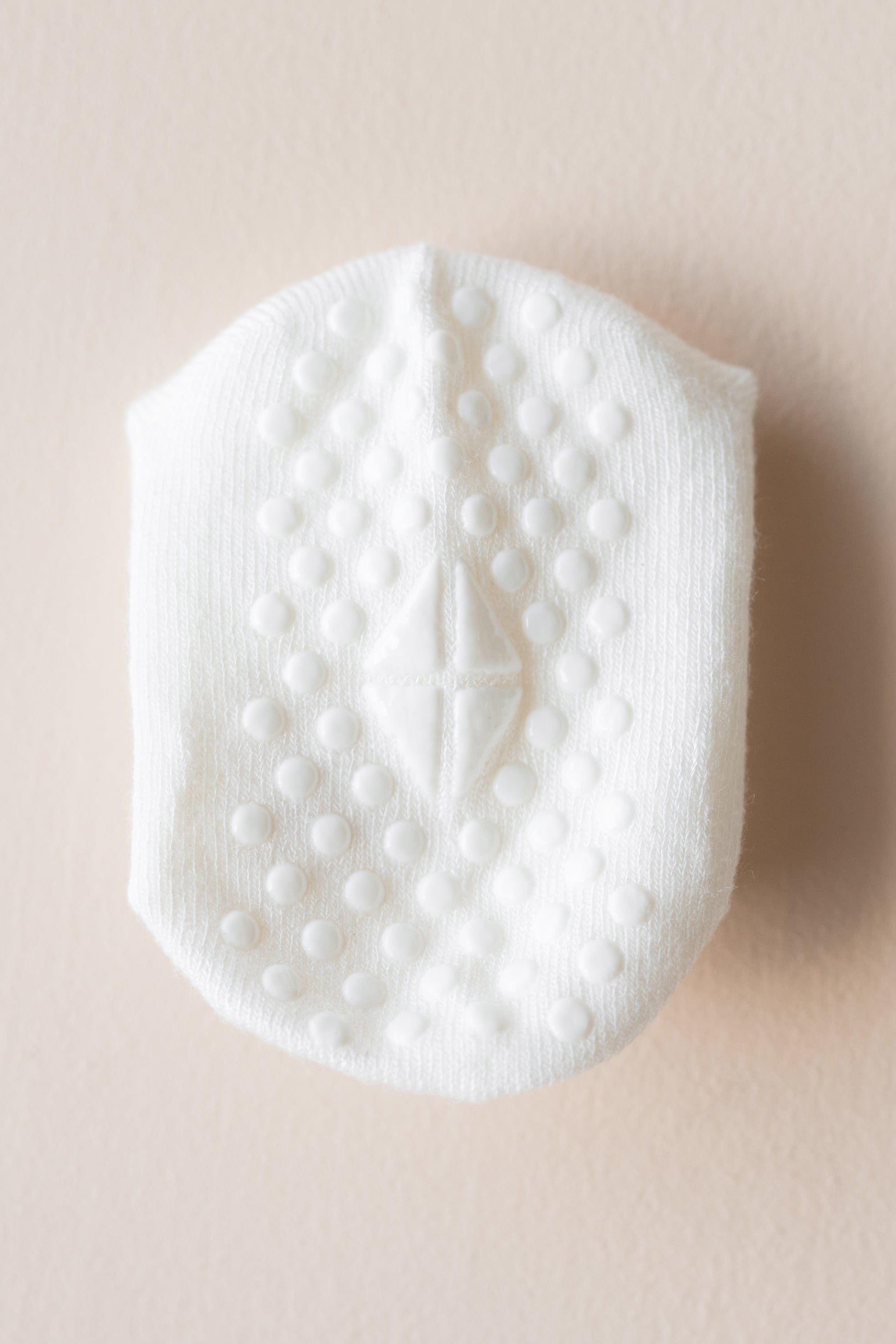 Grips on larger size of white ankle socks