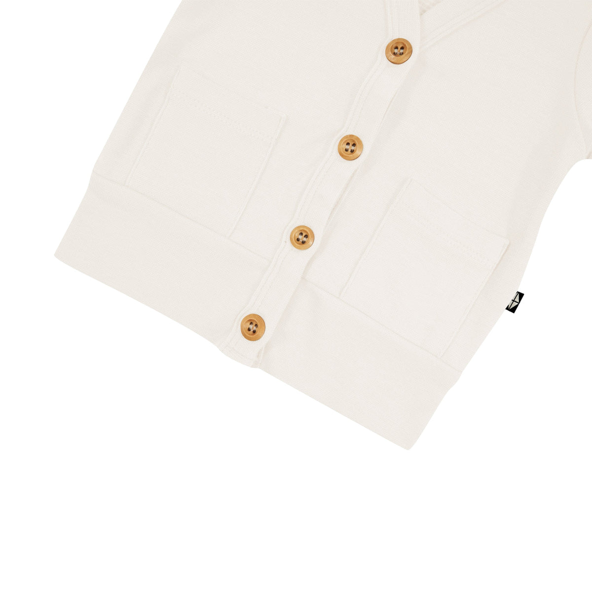 Wooden buttons on Kyte Baby Bamboo Jersey Cardigan in Oat