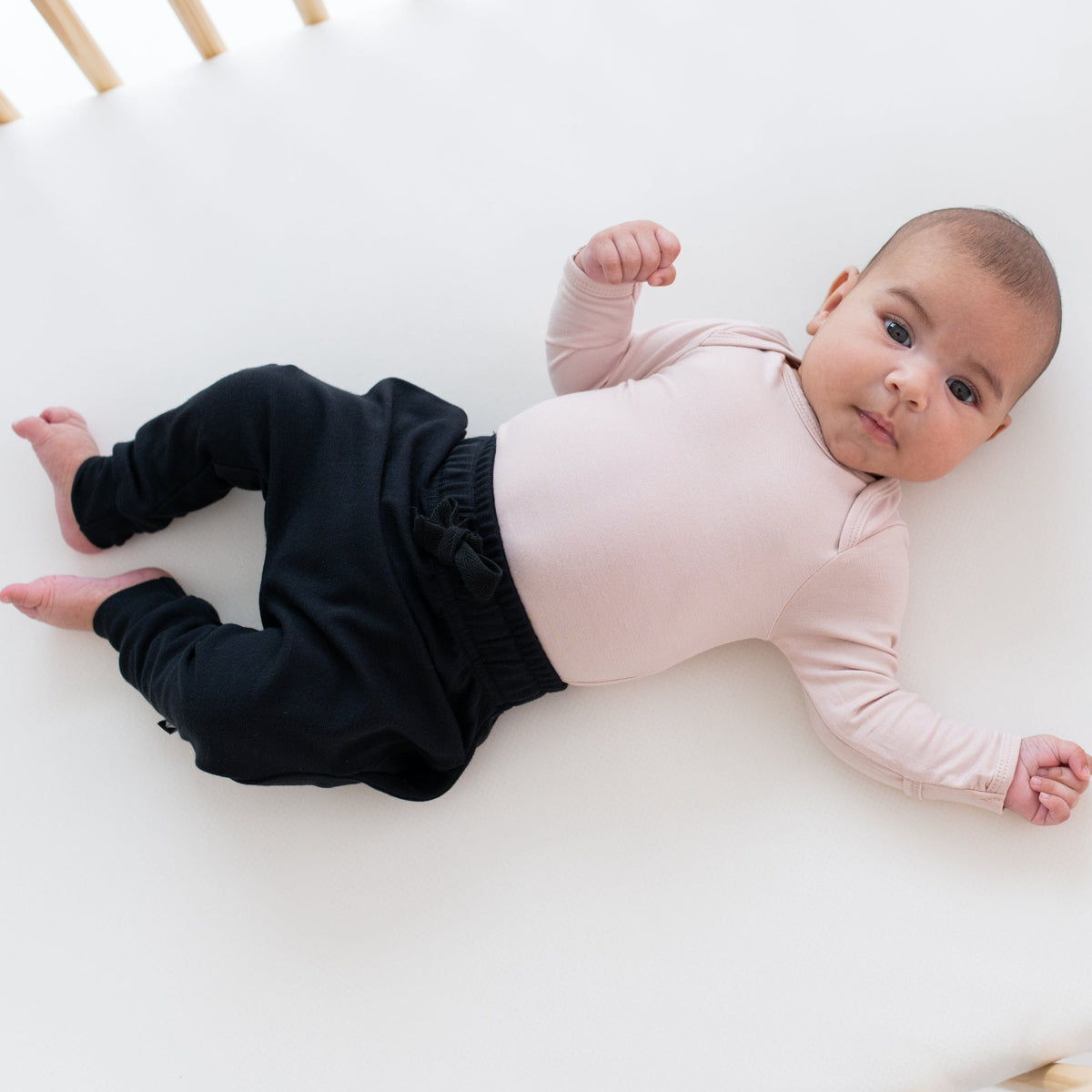 Infant wearing Kyte Baby Bamboo Jersey Harem Pants in Midnight