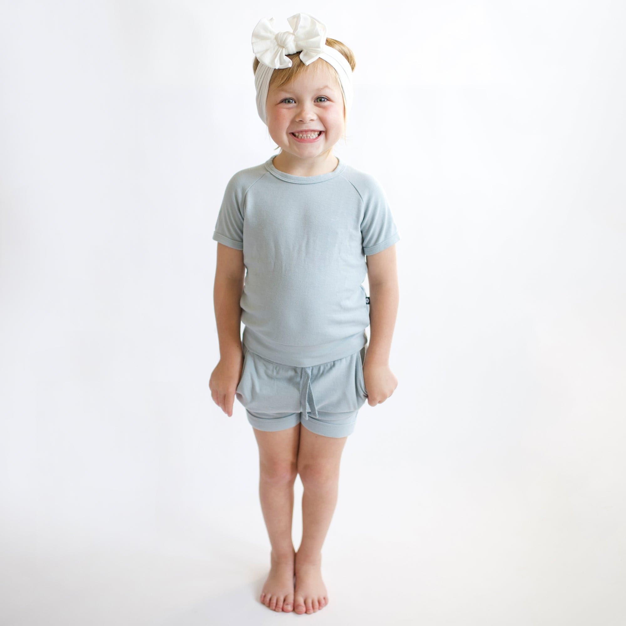 Girl wearing Kyte Baby Bamboo Jersey Short Sleeve Jogger Set in Fog