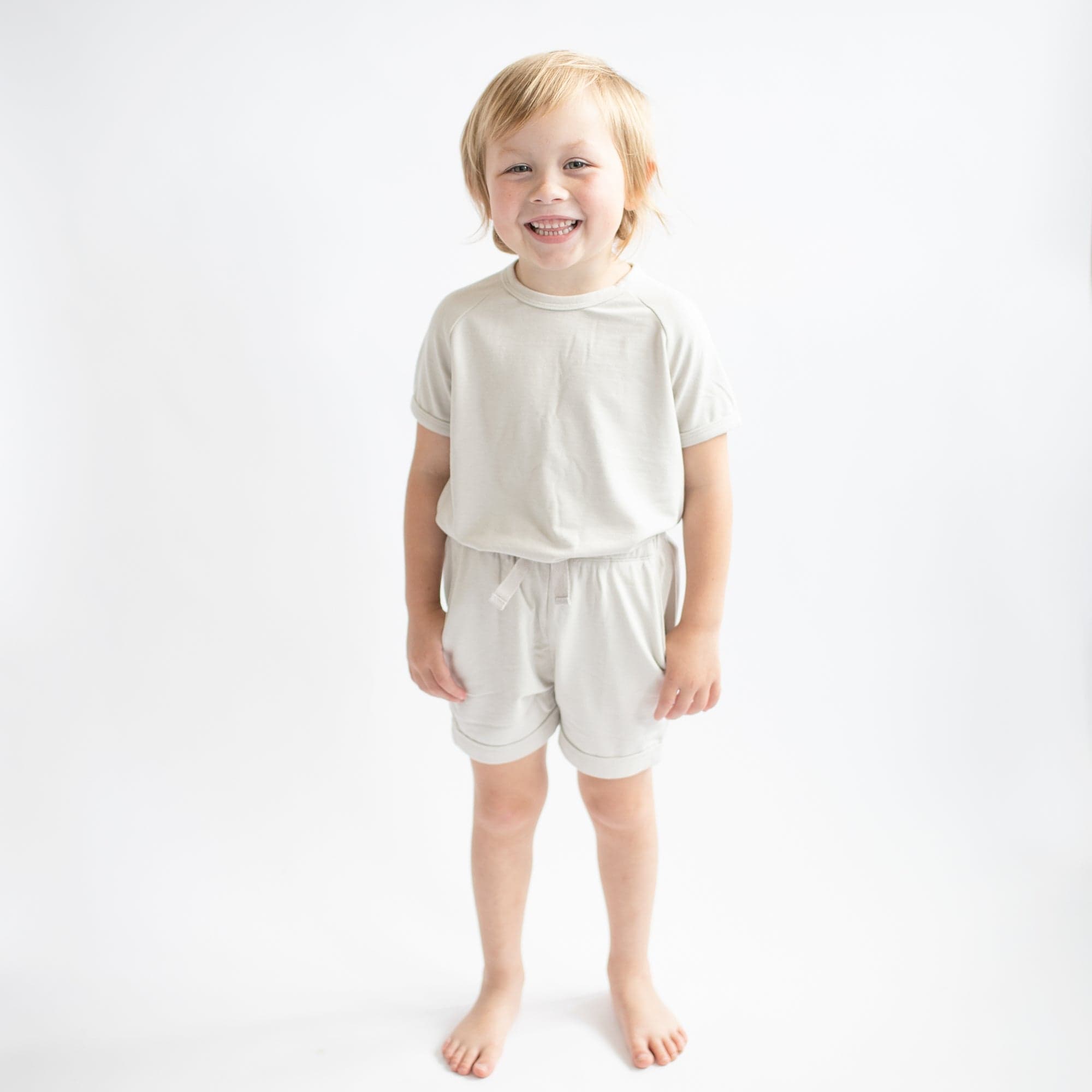 Toddler wearing Kyte Baby Bamboo Jersey Short Sleeve Jogger Set in Oat