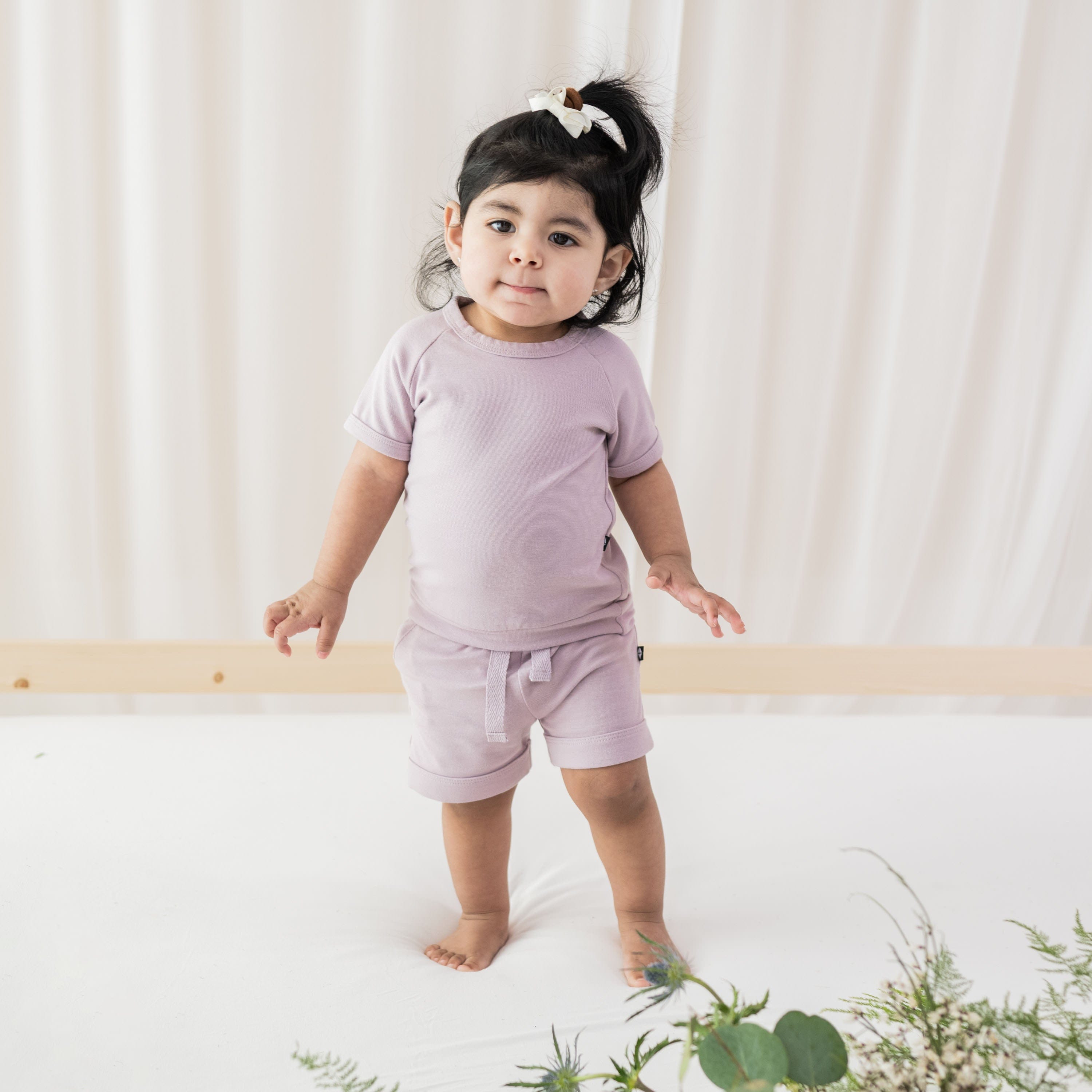 Toddler wearing Kyte Baby Bamboo Jersey Short Sleeve Jogger Set in Wisteria