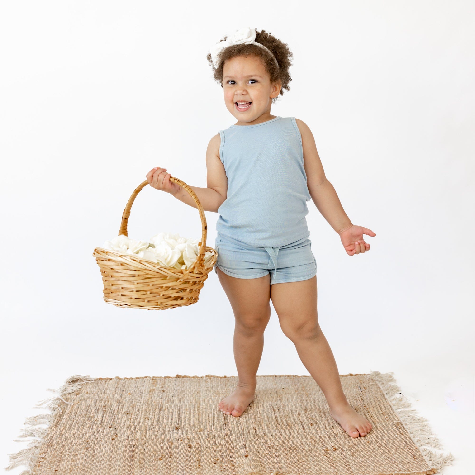 Toddler wearing Kyte Baby Bamboo Jersey Tank Jogger Set with shorts in Fog