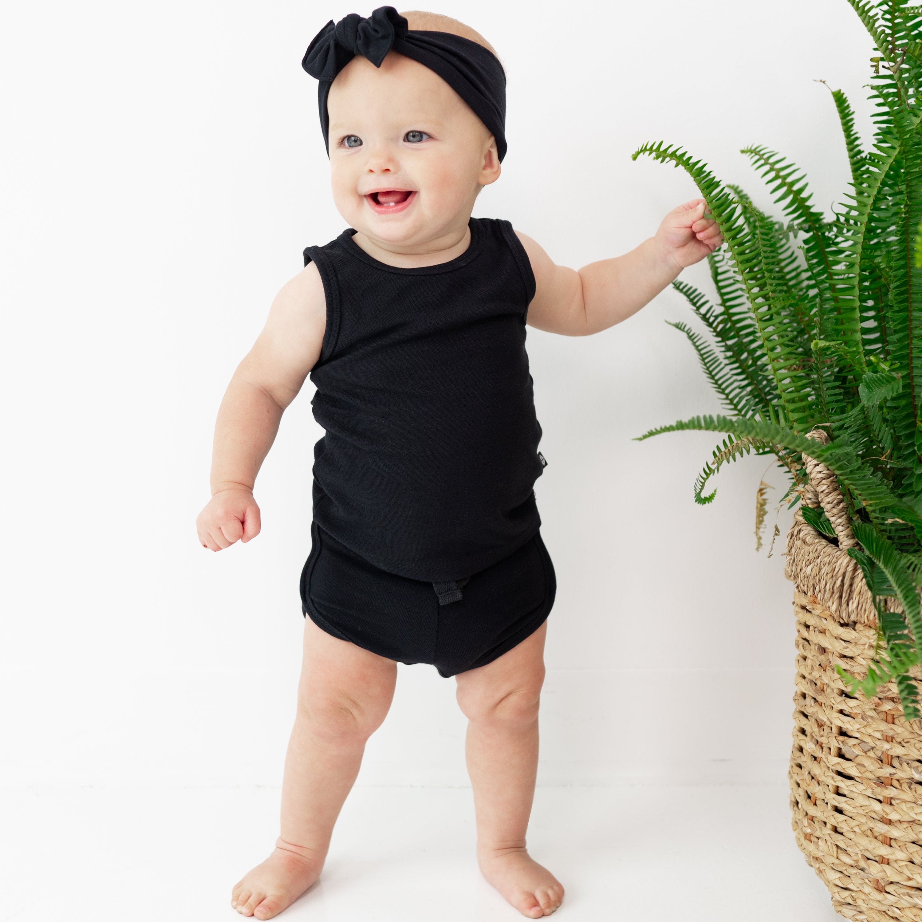 Infant wearing Kyte Baby Bamboo Jersey Tank Jogger Set in Midnight