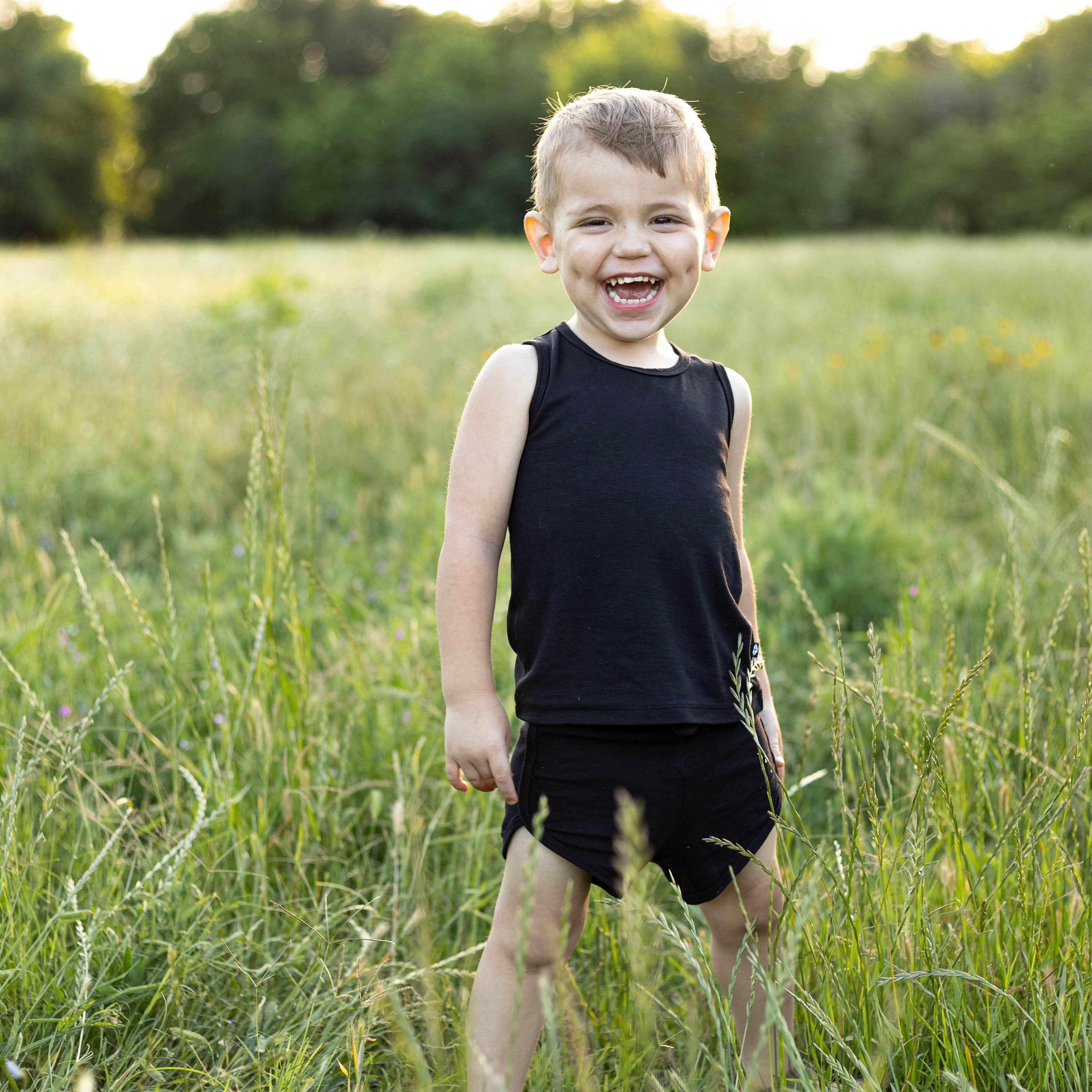 Toddler wearing Kyte Baby Bamboo Jersey Tank Jogger Set with shorts in Midnight