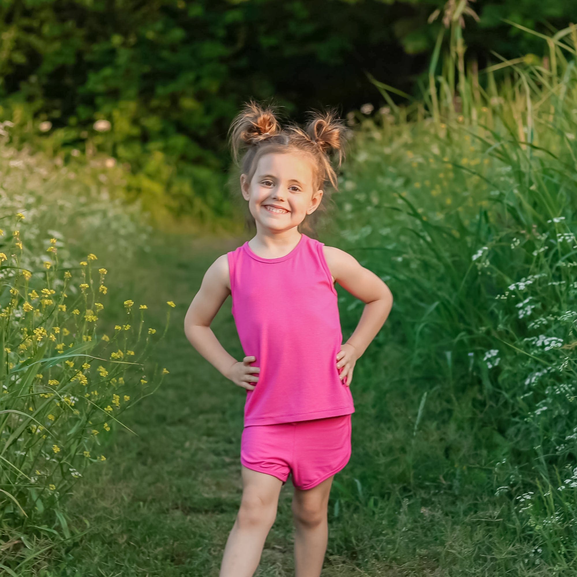 Toddler wearing Kyte Baby Bamboo Jersey Tank Jogger Set in Raspberry