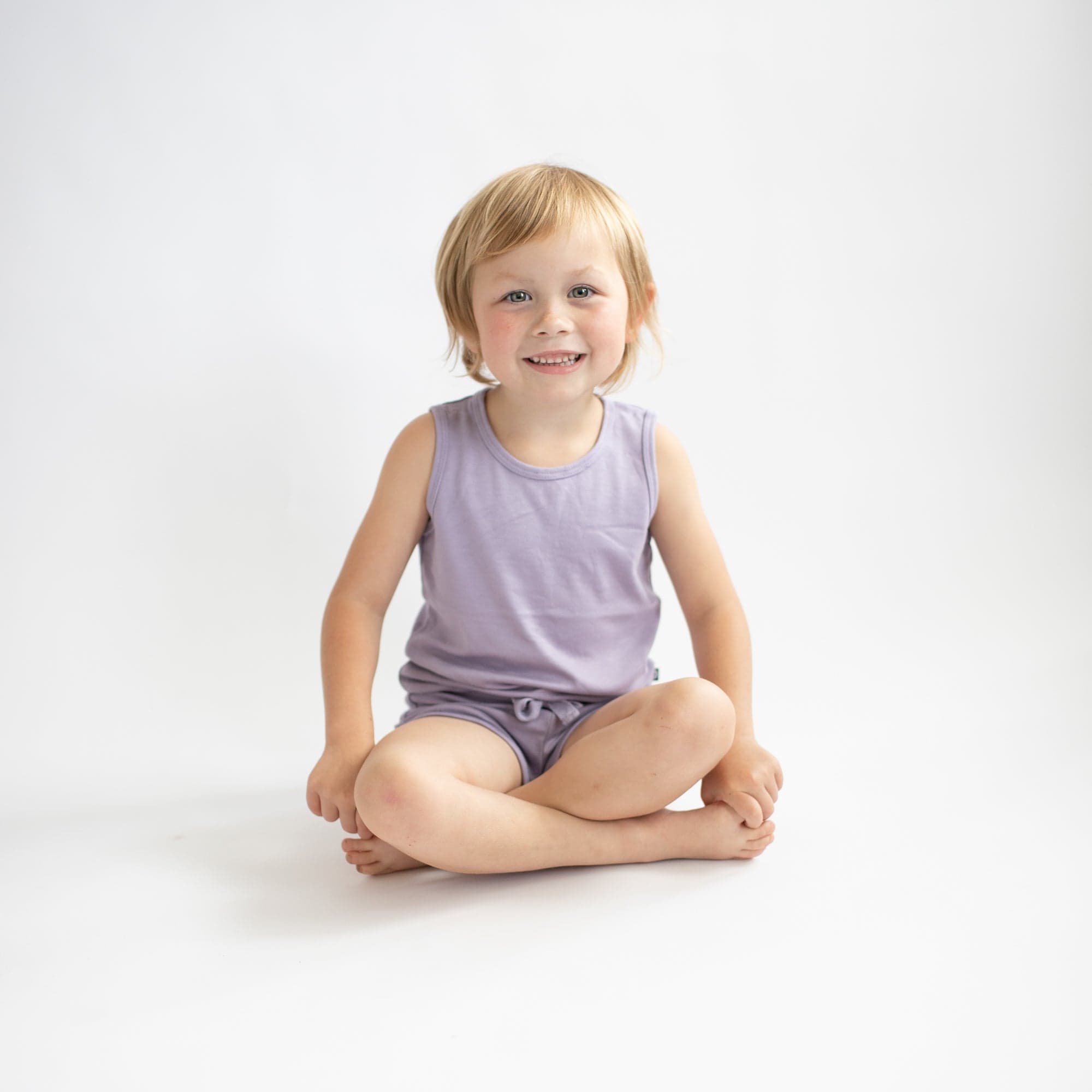 Toddler wearing Kyte Baby Bamboo Jersey Tank Jogger Set with shorts in Taro