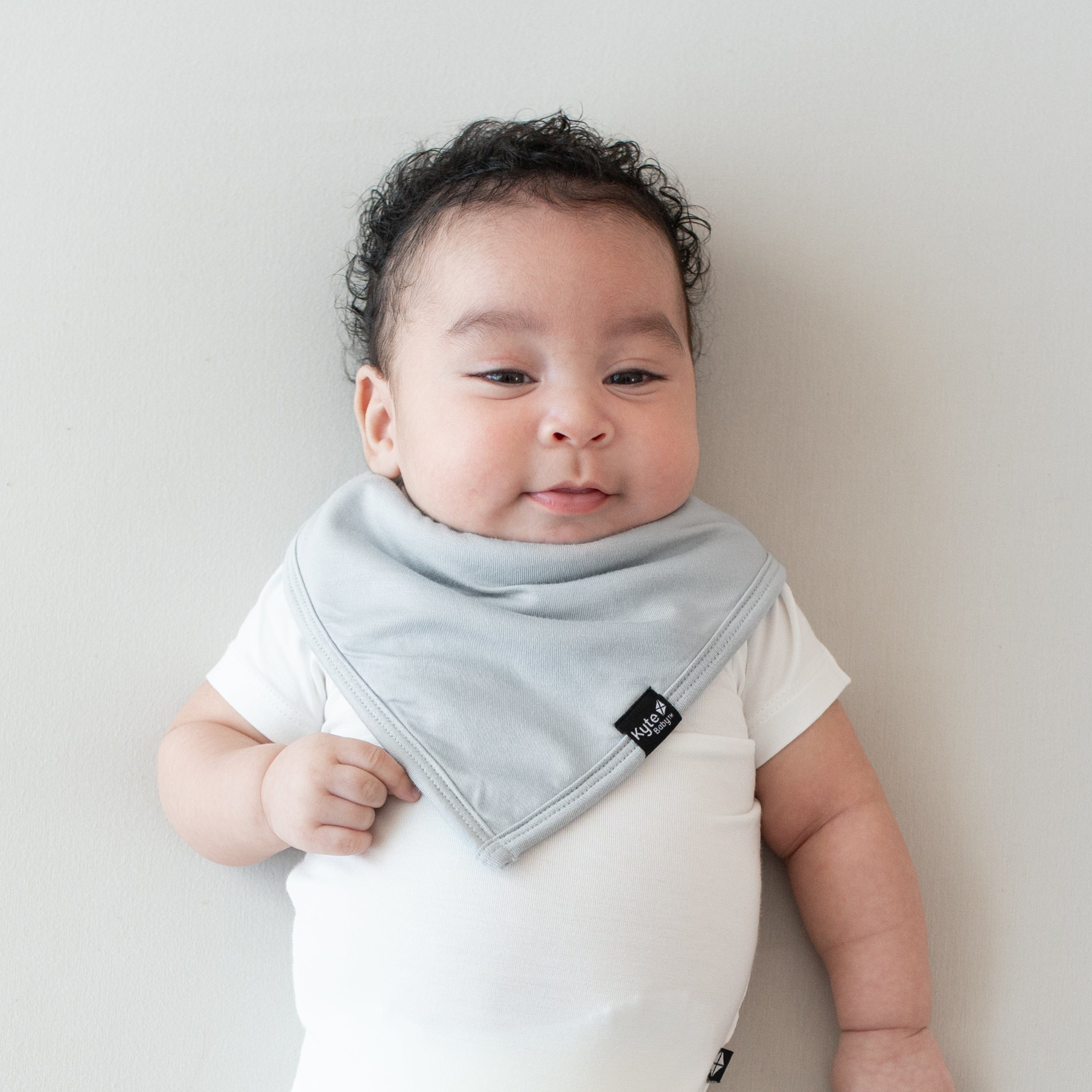 Infant modeling the Kyte Baby Bib in Storm