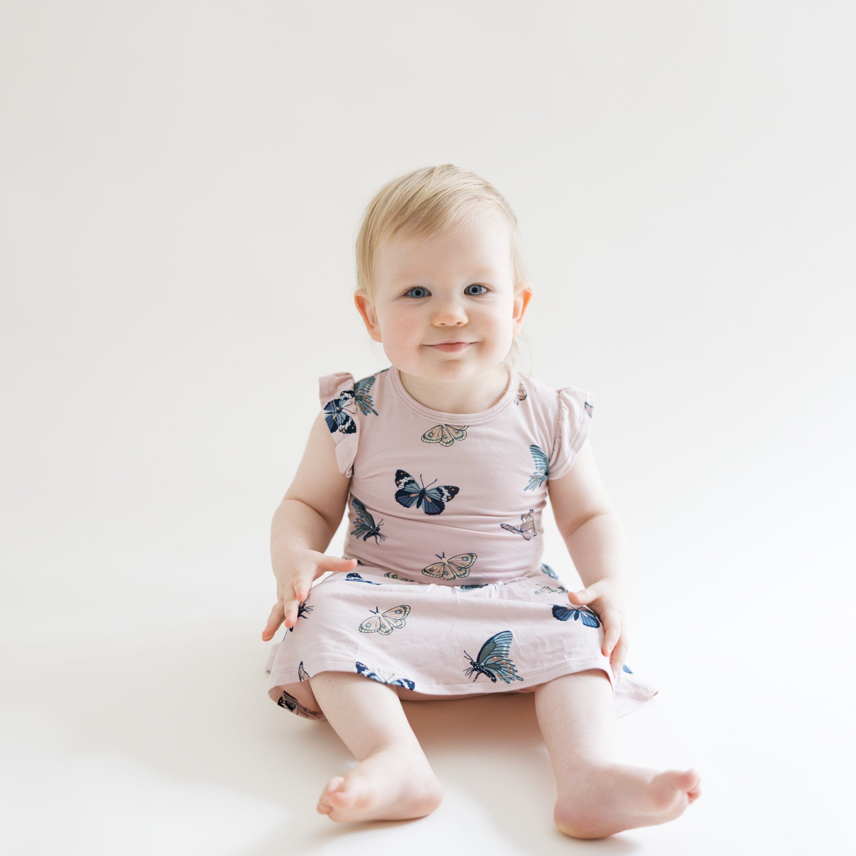 Toddler wearing bamboo pink Twirl Bodysuit Dress in Blush Butterfly