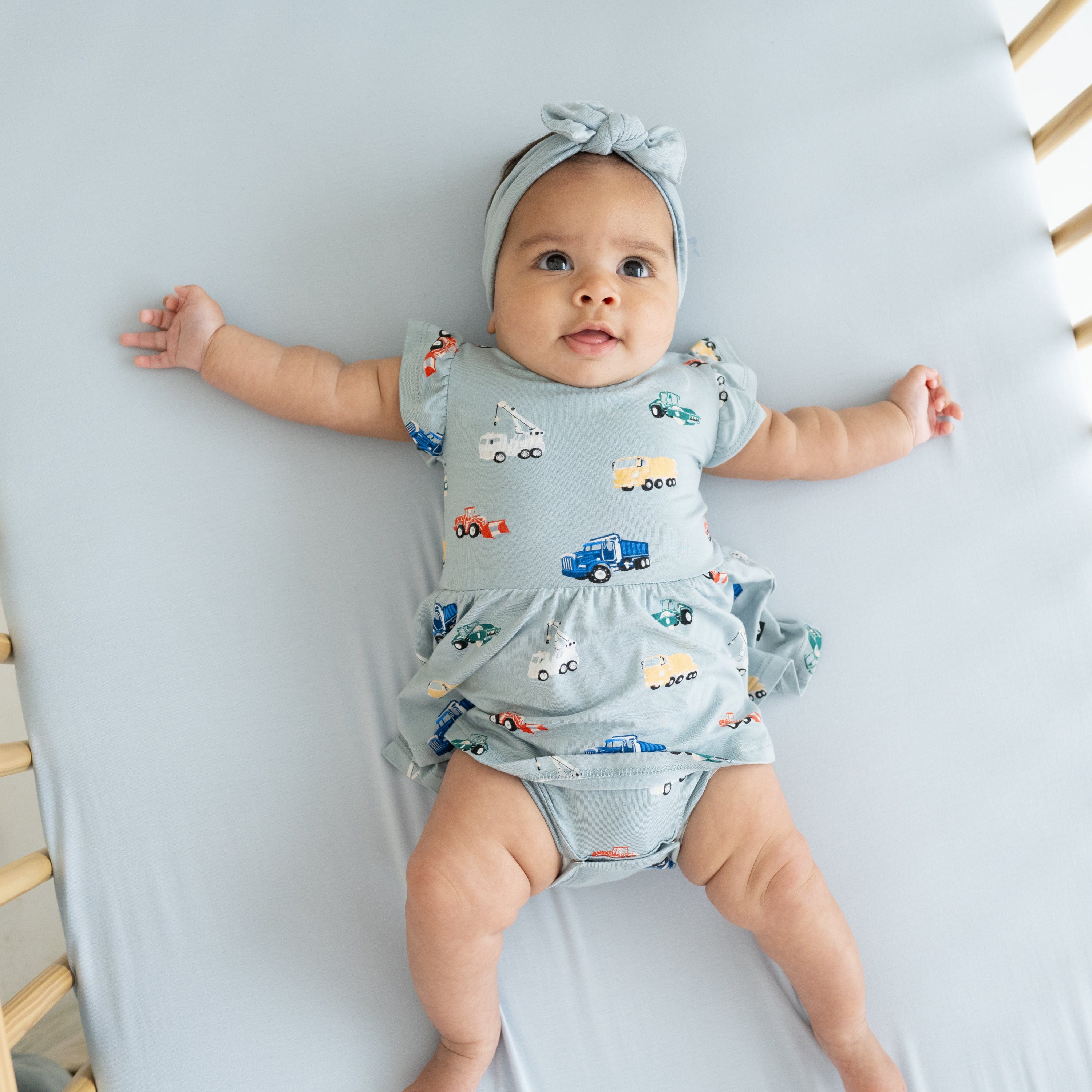 Baby wearing Twirl Bodysuit Dress in Construction