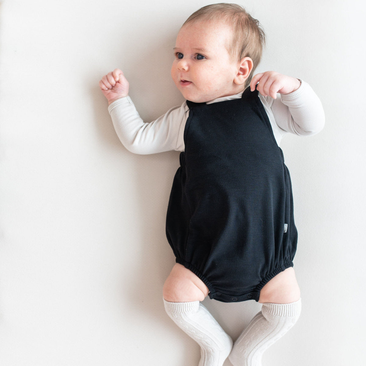 Infant wearing Kyte Baby Bamboo Jersey Bubble Overall in Midnight