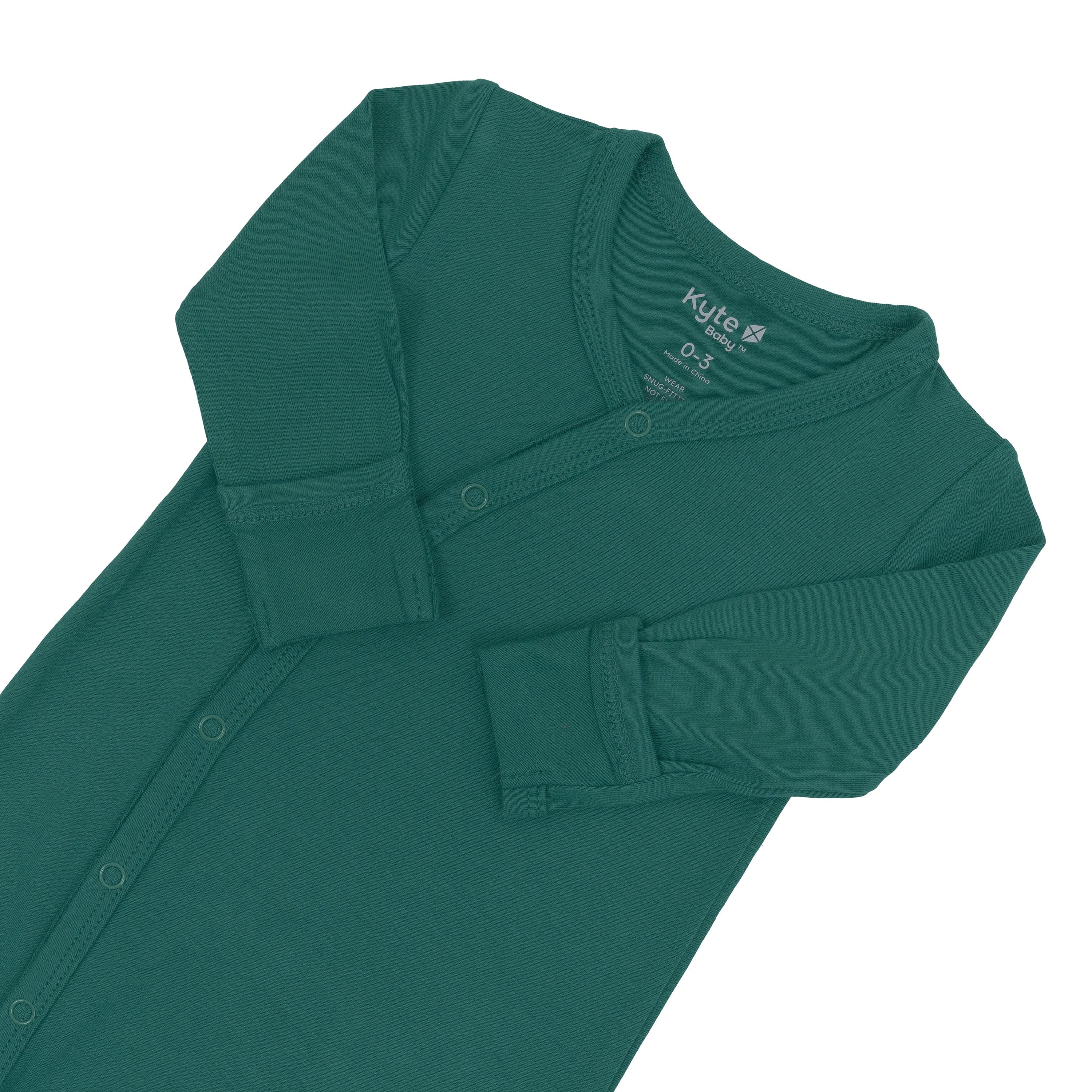 Fold-over cuffs with arms folded inwards on Kyte Baby Bundler in Emerald