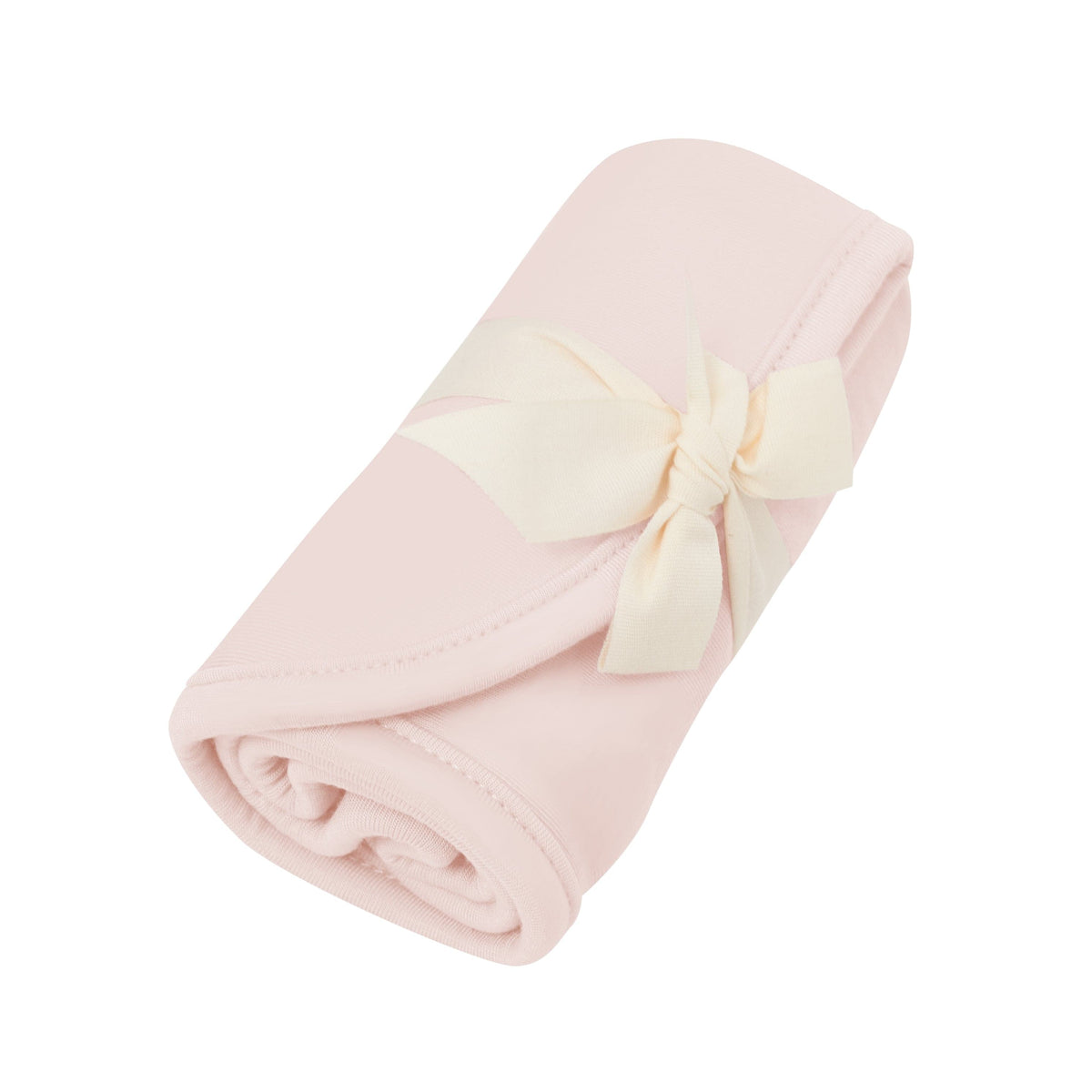 Rolled up Kyte Baby Burp Cloth in Blush tied with a bow