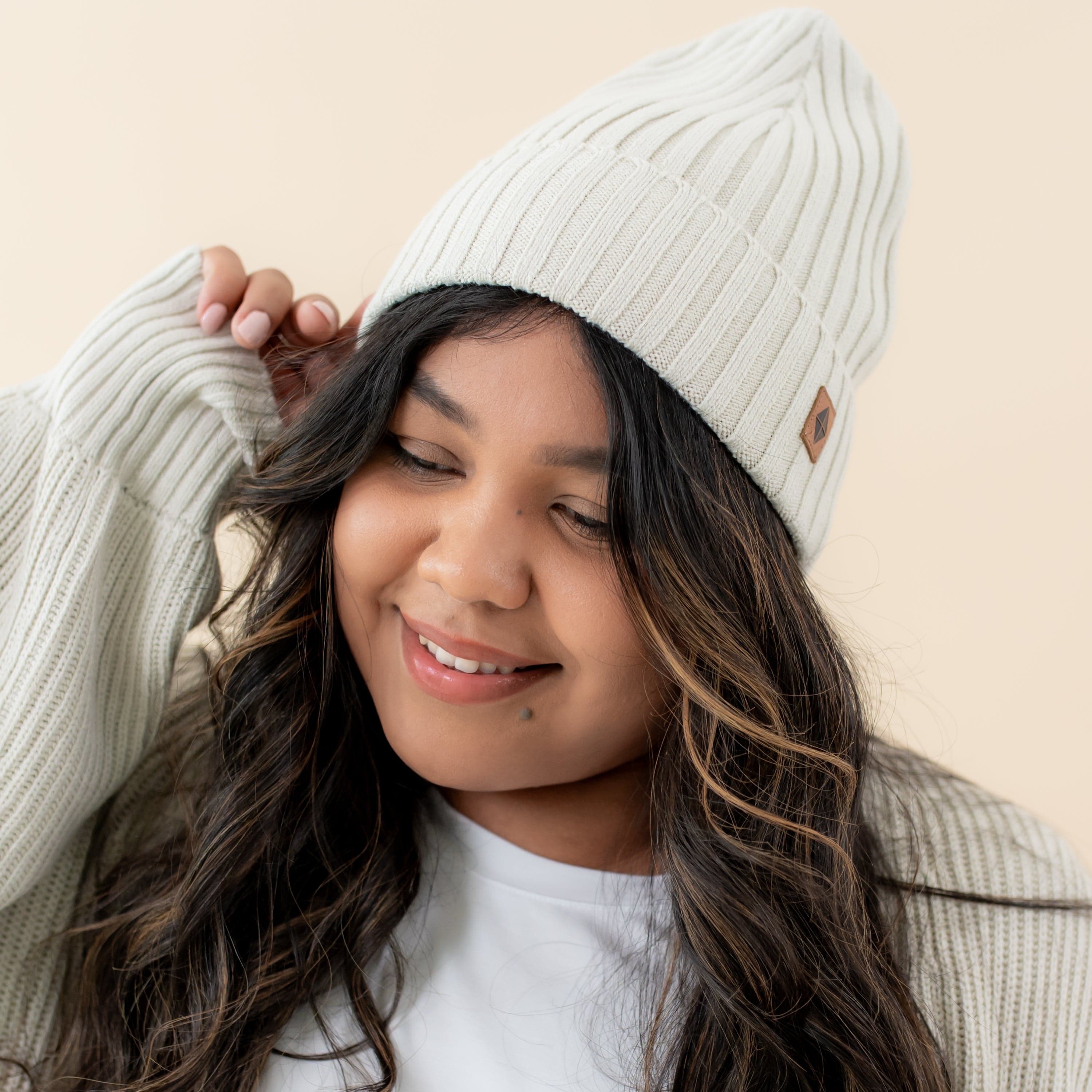 Woman wearing One Size Kyte Baby Chunky Knit Adult Ribbed Beanie in Oat neutral