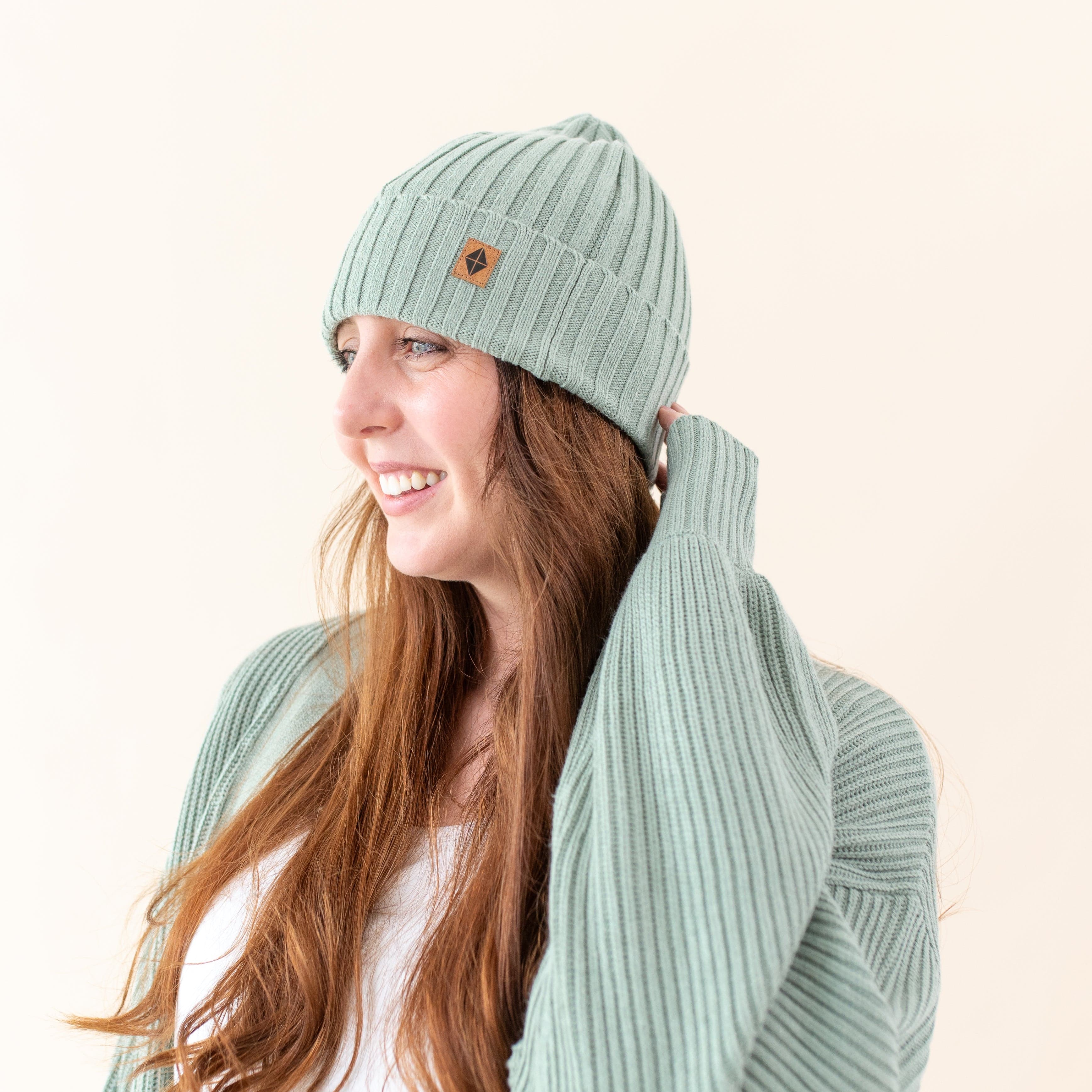 Woman wearing Kyte Baby soft and stretchy Chunky Knit Adult Ribbed Beanie in Thyme
