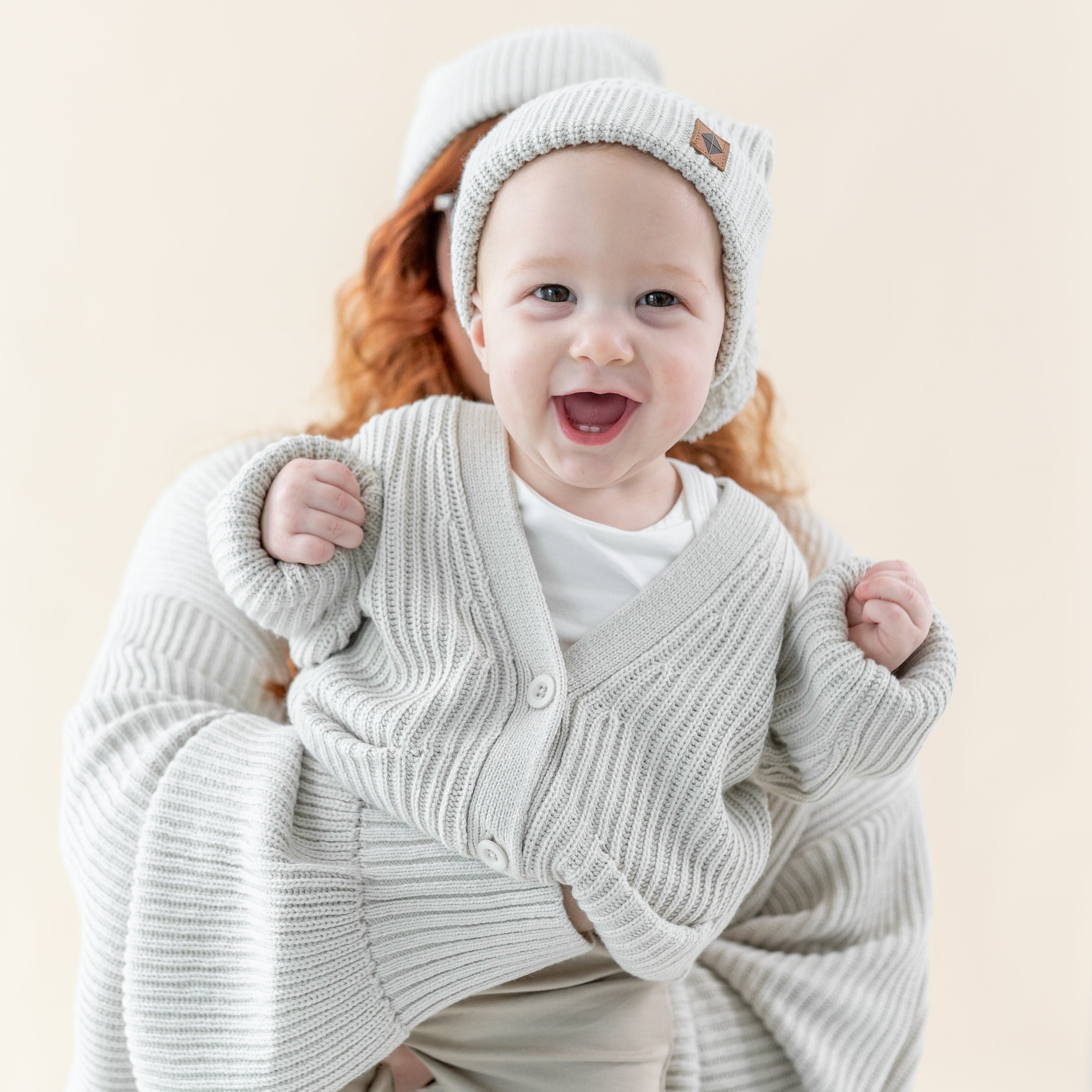 Child wearing Kyte Baby Chunky Knit Oversized Cardigan in Oat