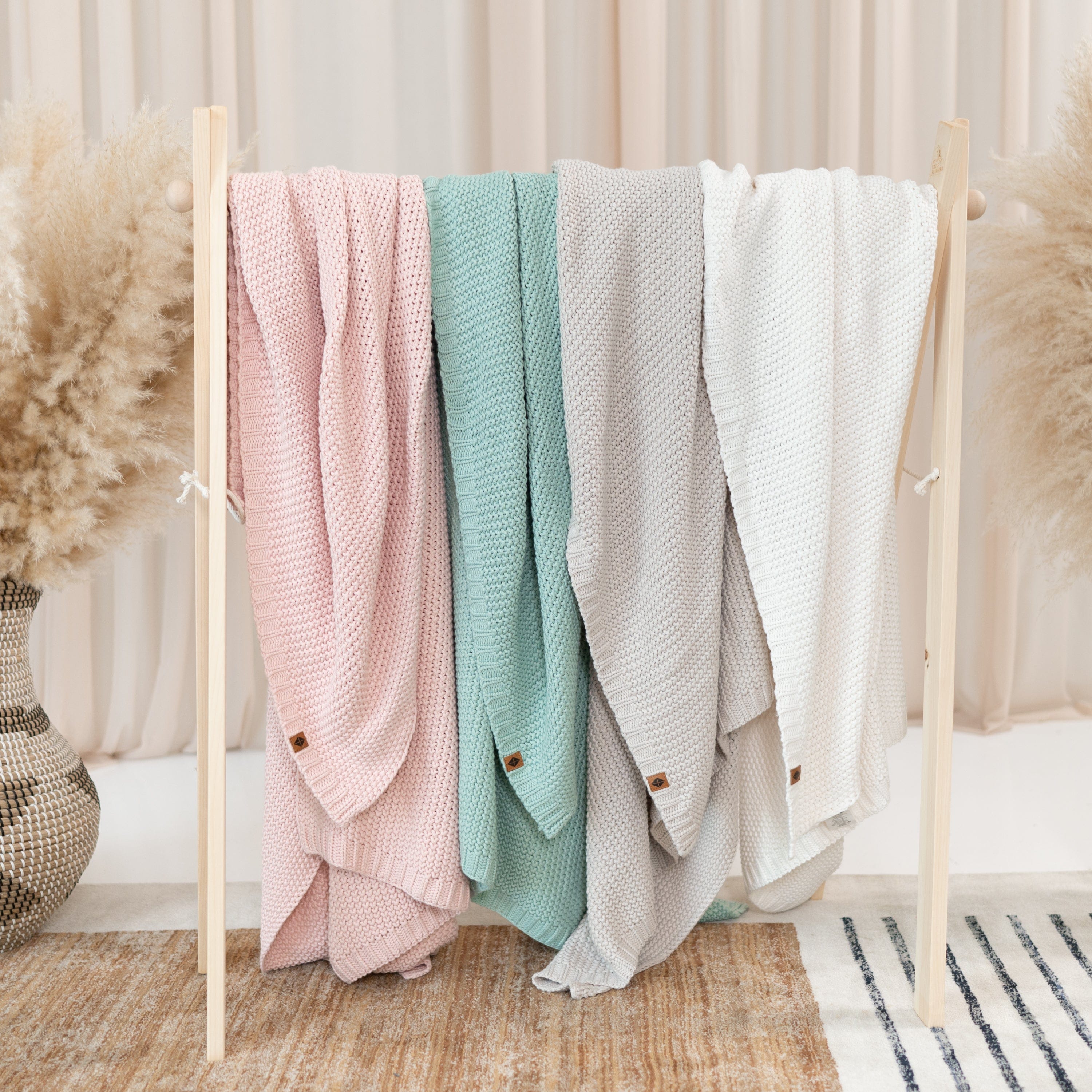 Kyte Baby Chunky Knit Toddler Blankets Hanging in Core Colors