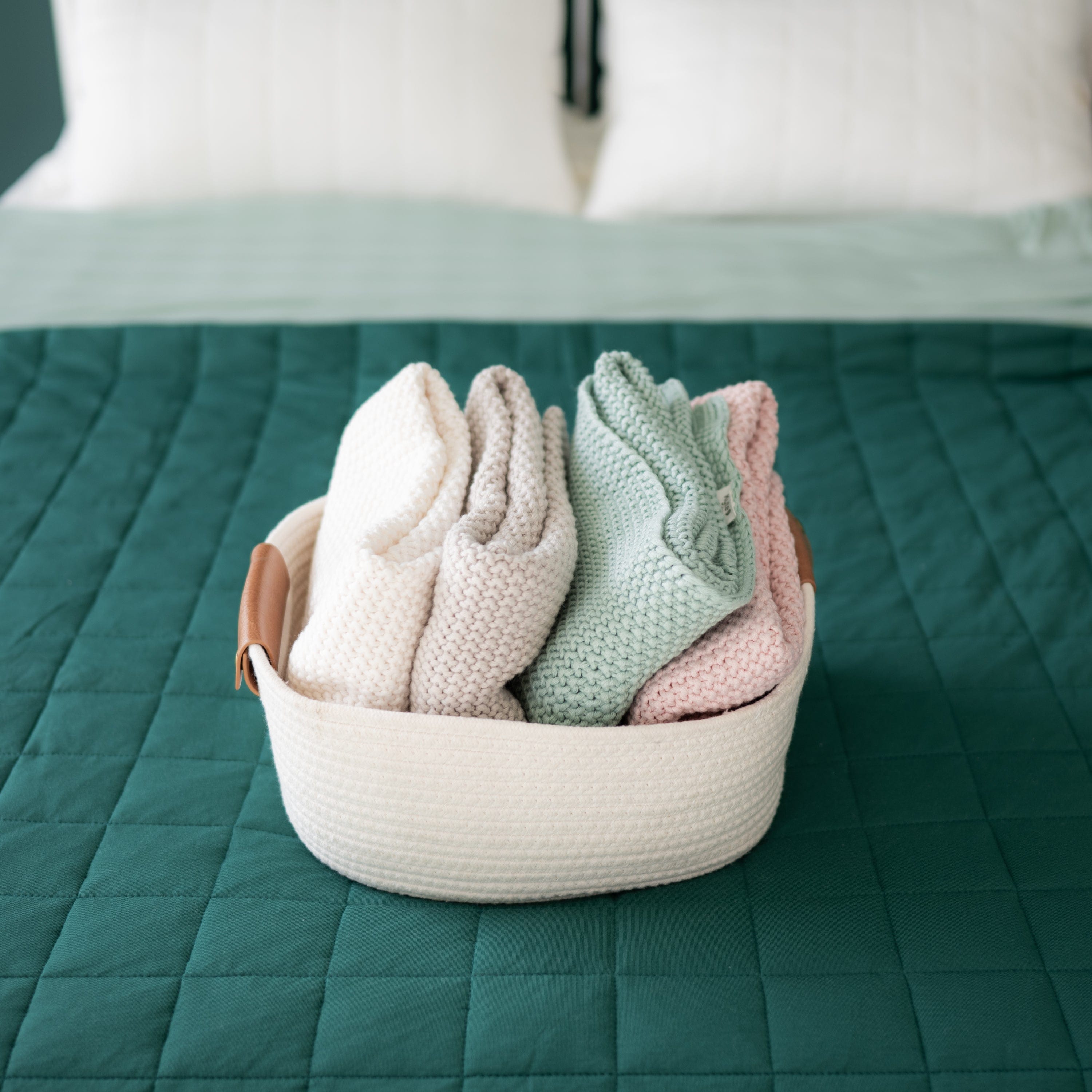 Kyte Baby Chunky Knit Toddler Blankets Folded in Basket