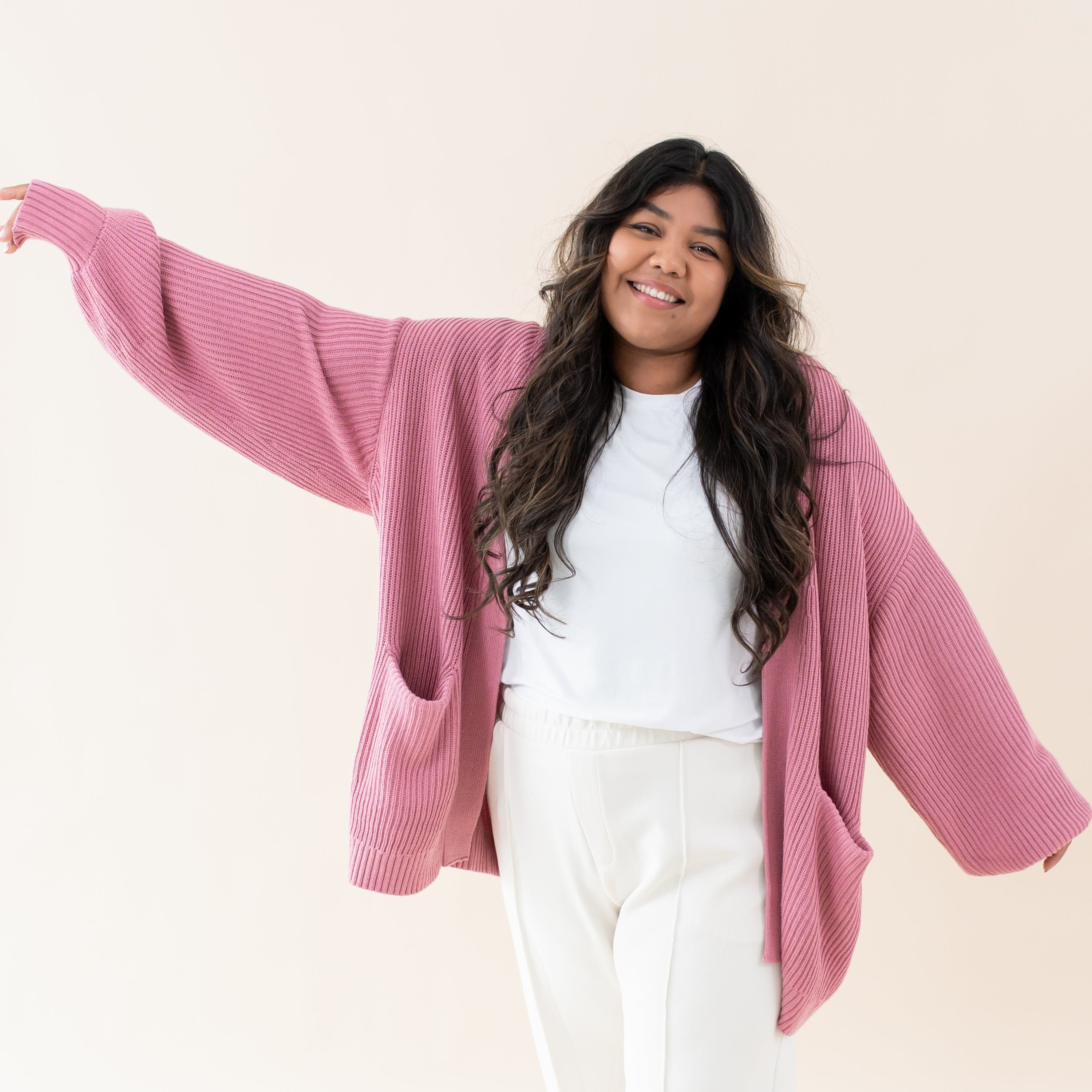 Woman wearing Kyte Baby Chunky Knit Women's Oversized Cardigan in Apple Blossom