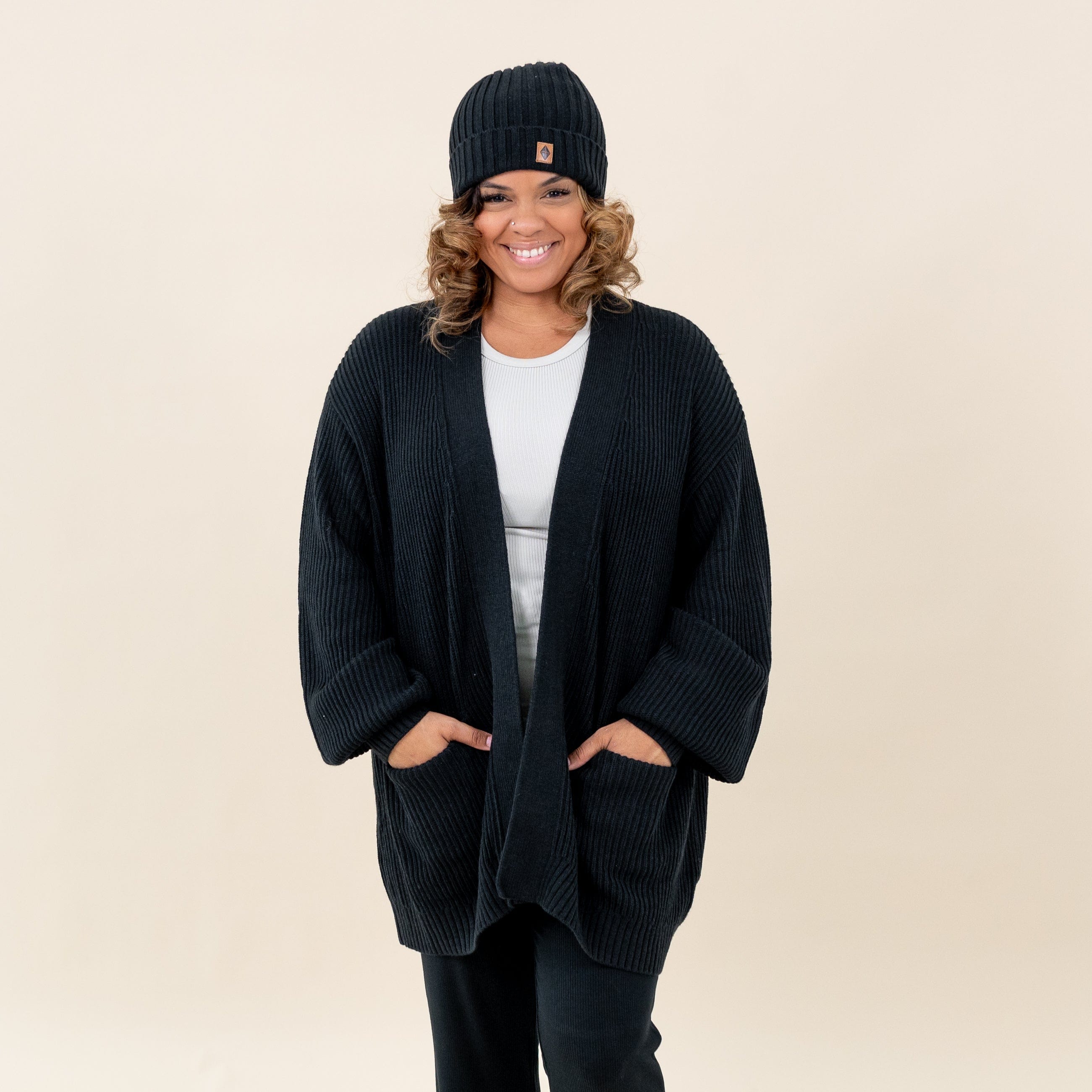 Woman wearing Kyte Baby Chunky Knit Women's Oversized Cardigan in Midnight