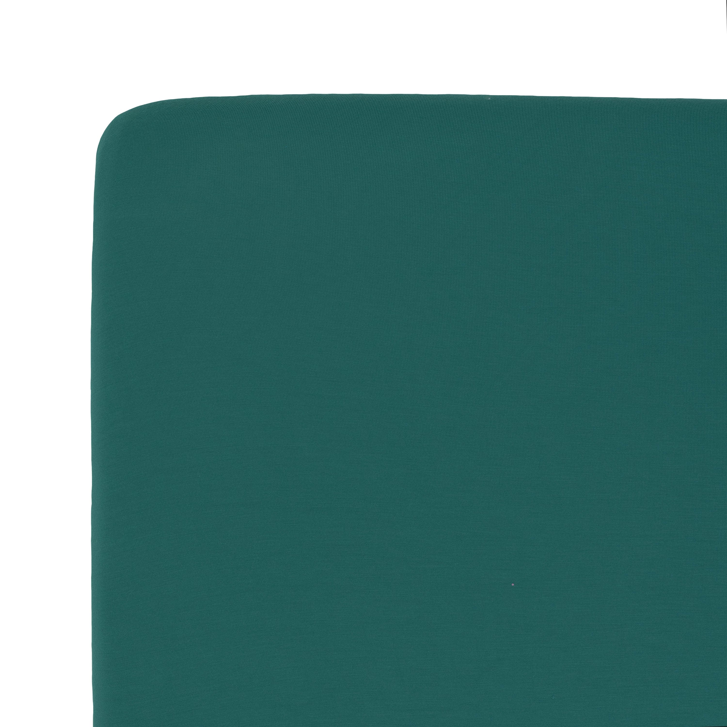 Corner of the Kyte Baby Crib Sheet in Emerald