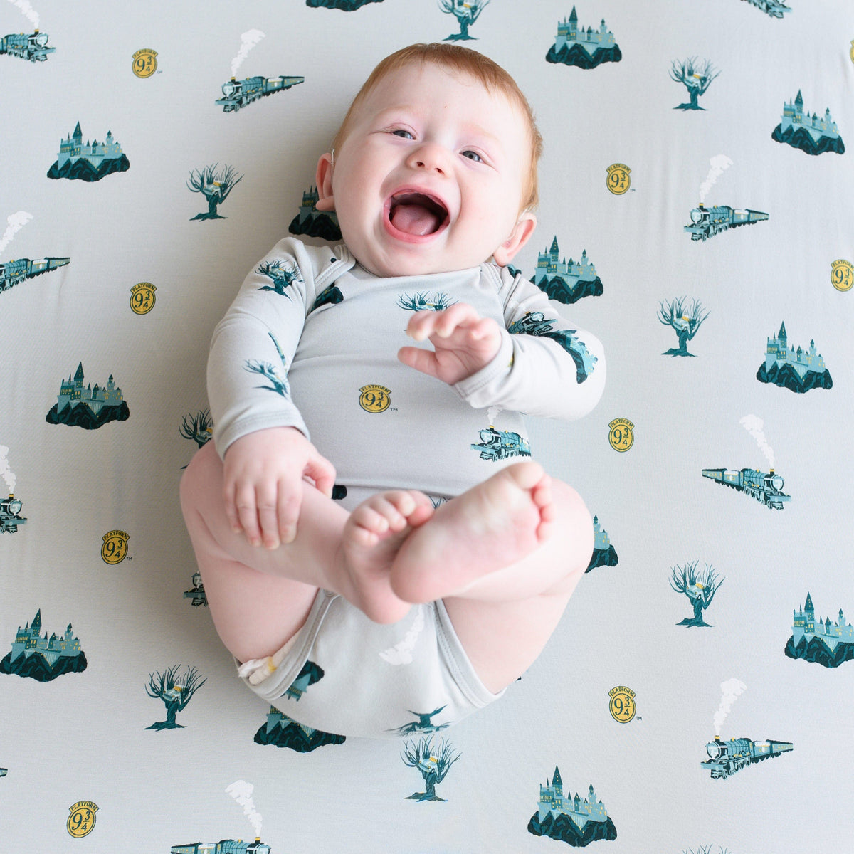 Infant laying on Kyte Baby Crib Sheet in Journey
