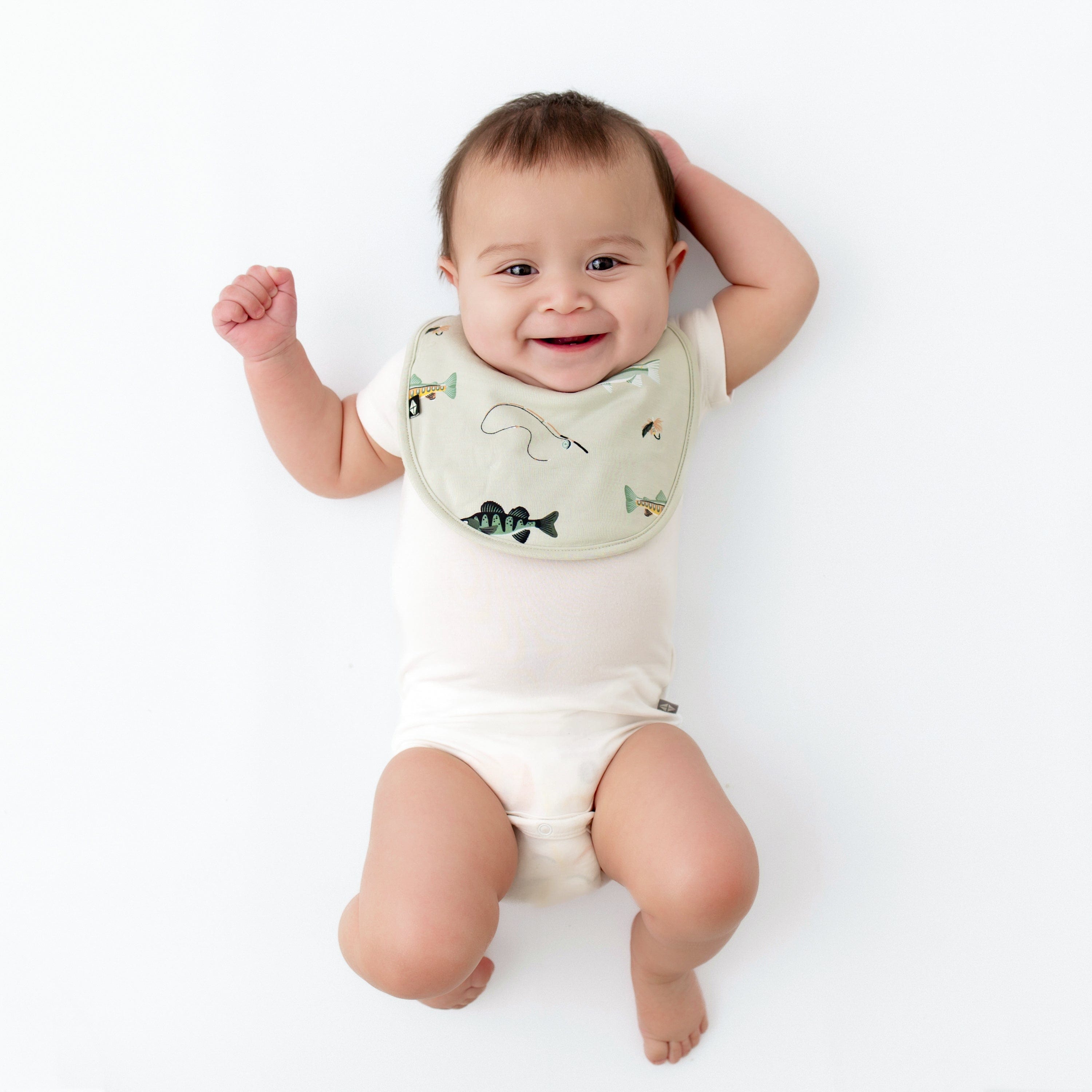 Infant wearing Kyte Baby Cushy Bamboo Bib in Fishing