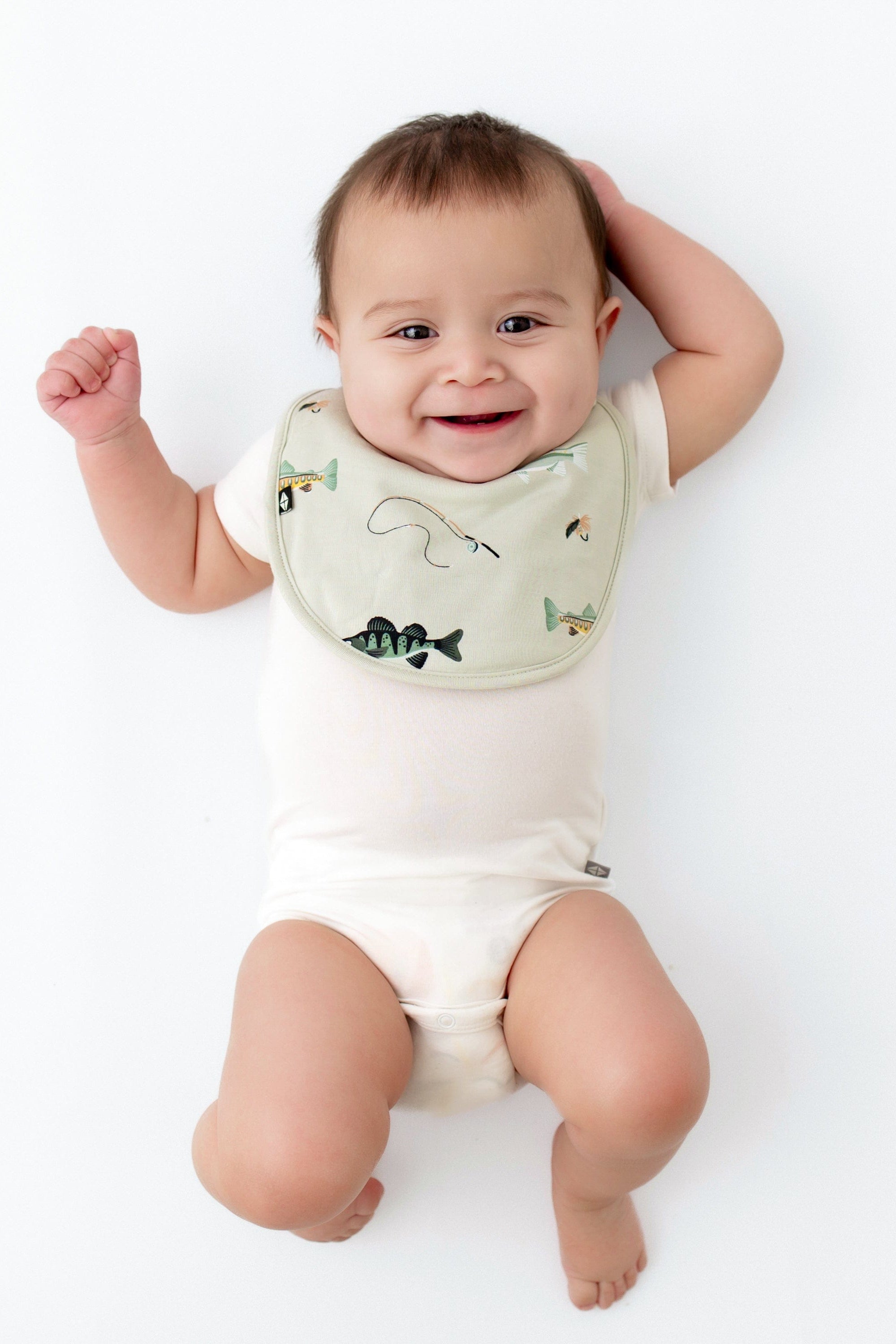 Infant wearing Kyte Baby Cushy Bamboo Bib in Fishing