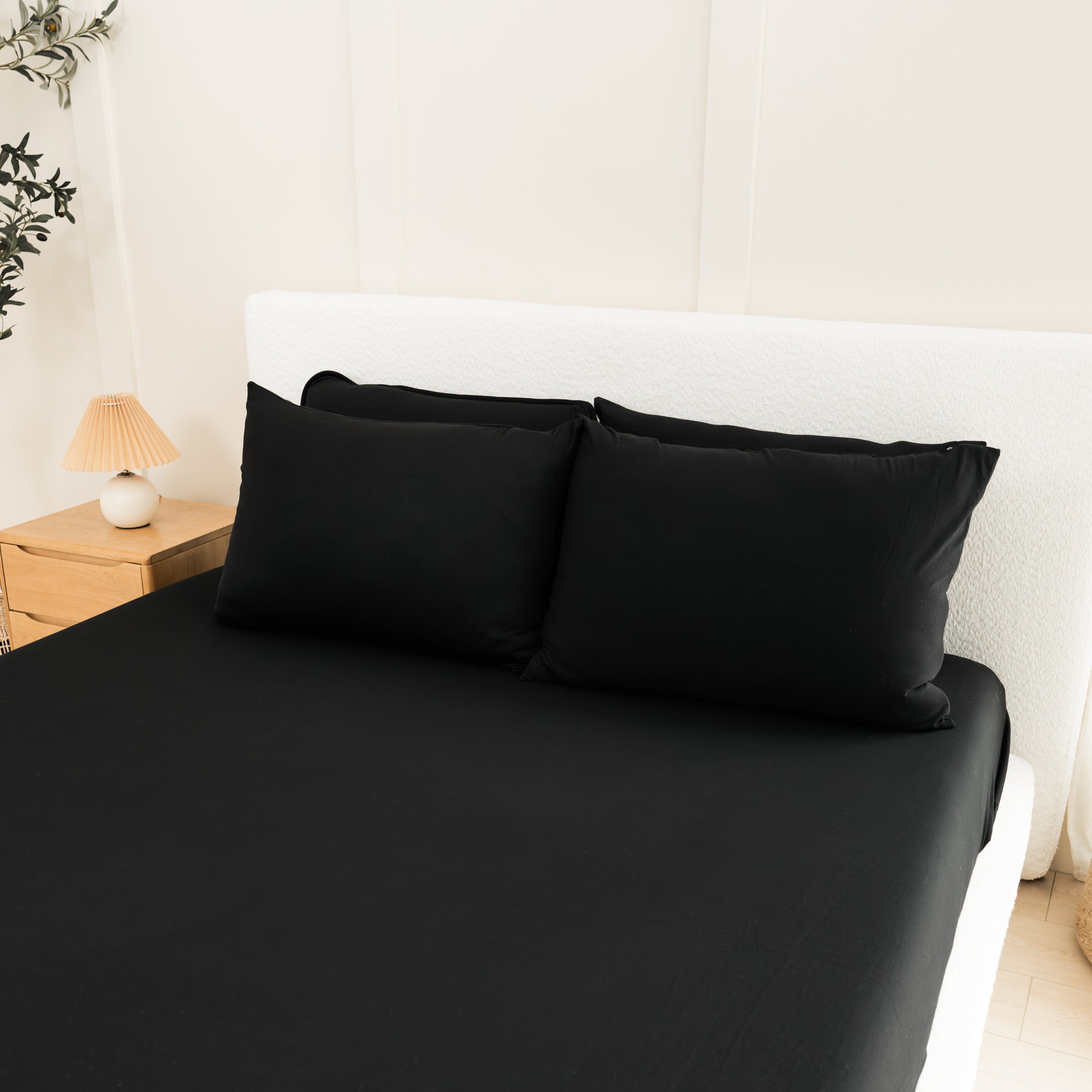 Bed Made with Kyte Baby Fitted Sheet with Pillowcases in Midnight