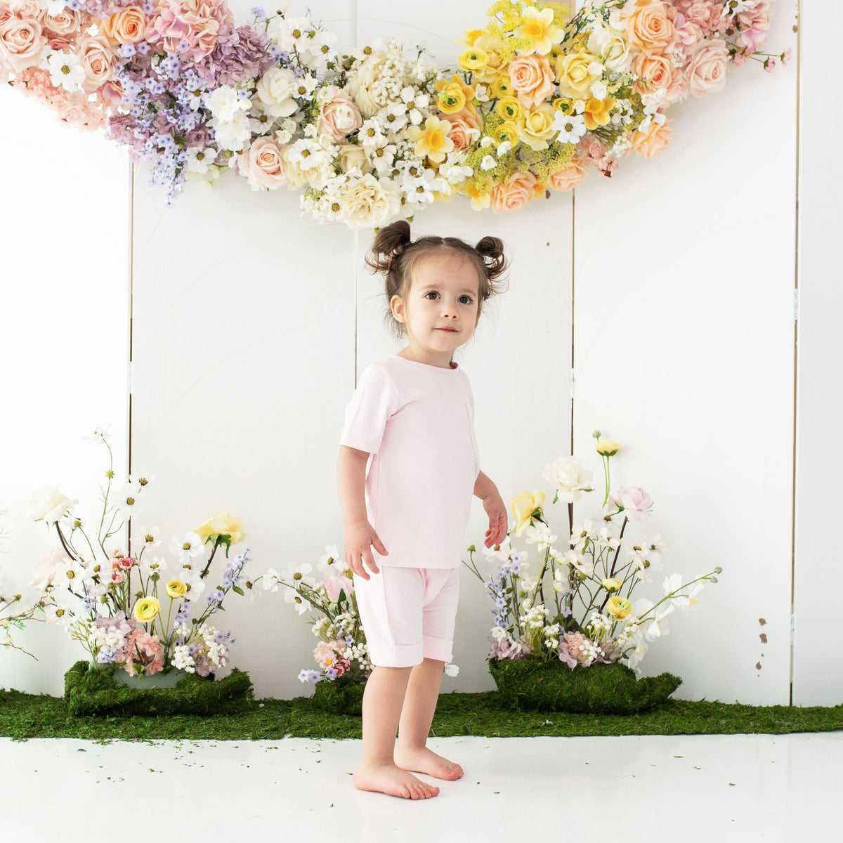 Girl wearing Kyte Baby Harem Shorts in Sakura