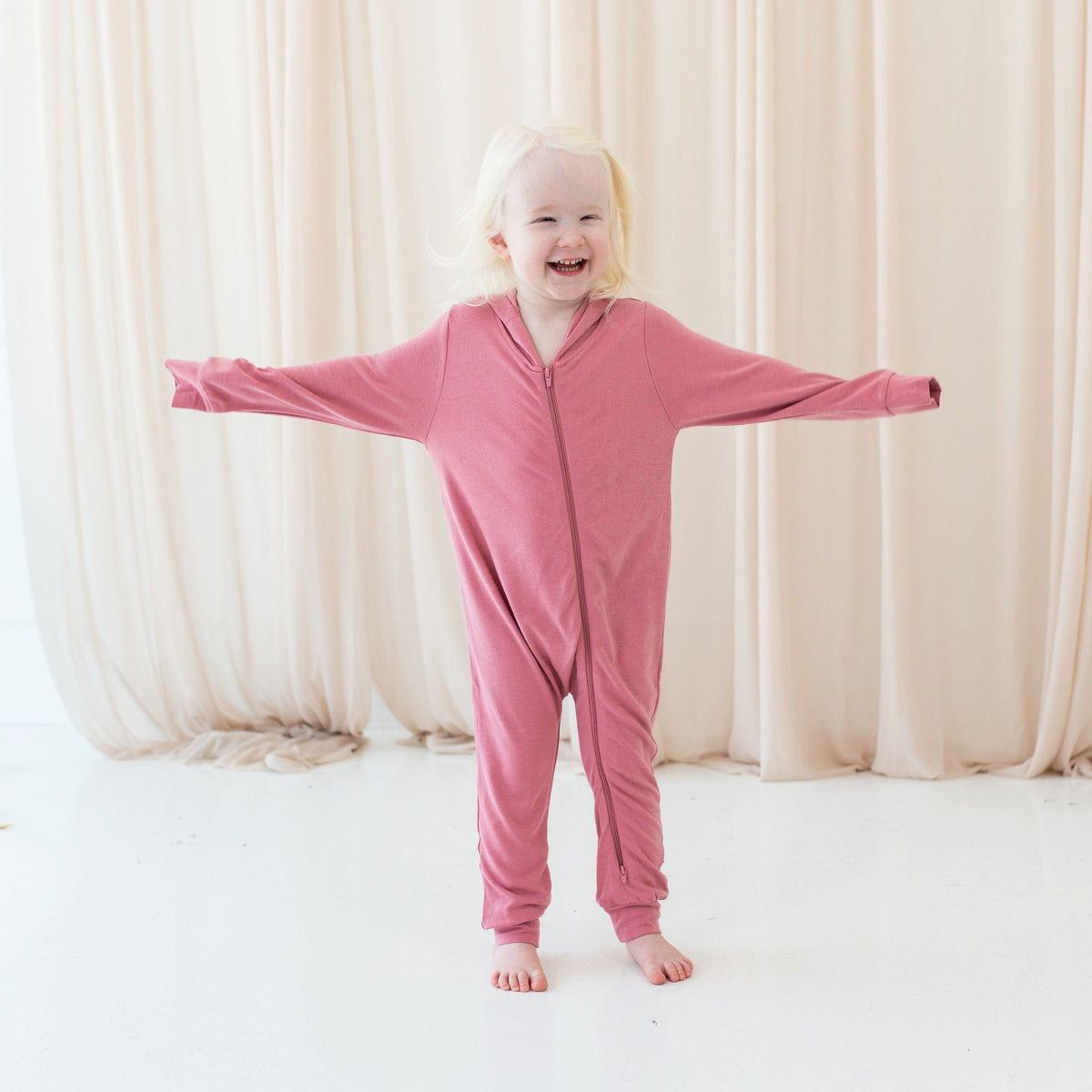 Child wearing Bamboo Jersey Hooded Zippered Romper in Apple Blossom