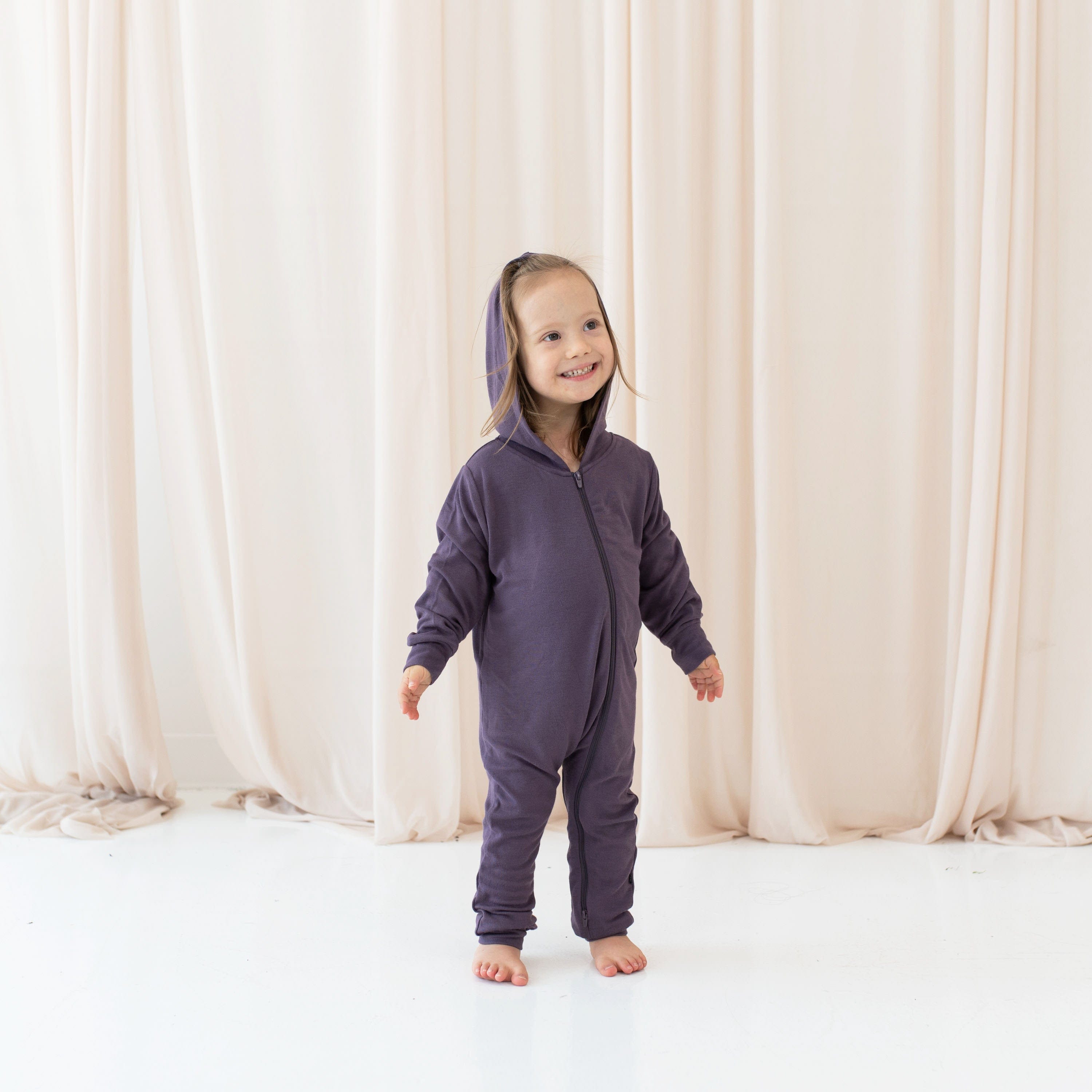 Girl wearing Bamboo Jersey Hooded Zippered Romper in Currant