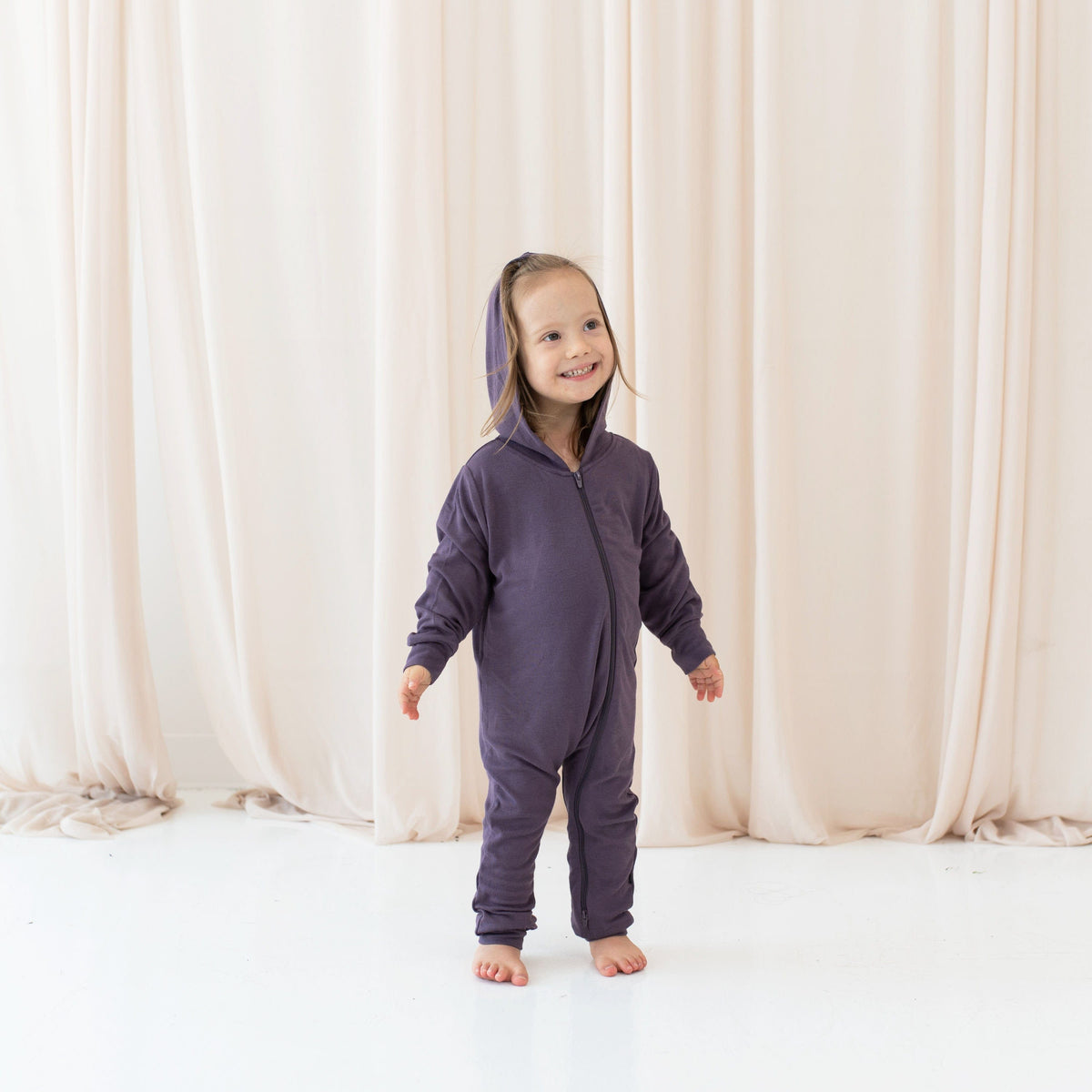 Girl wearing Bamboo Jersey Hooded Zippered Romper in Currant