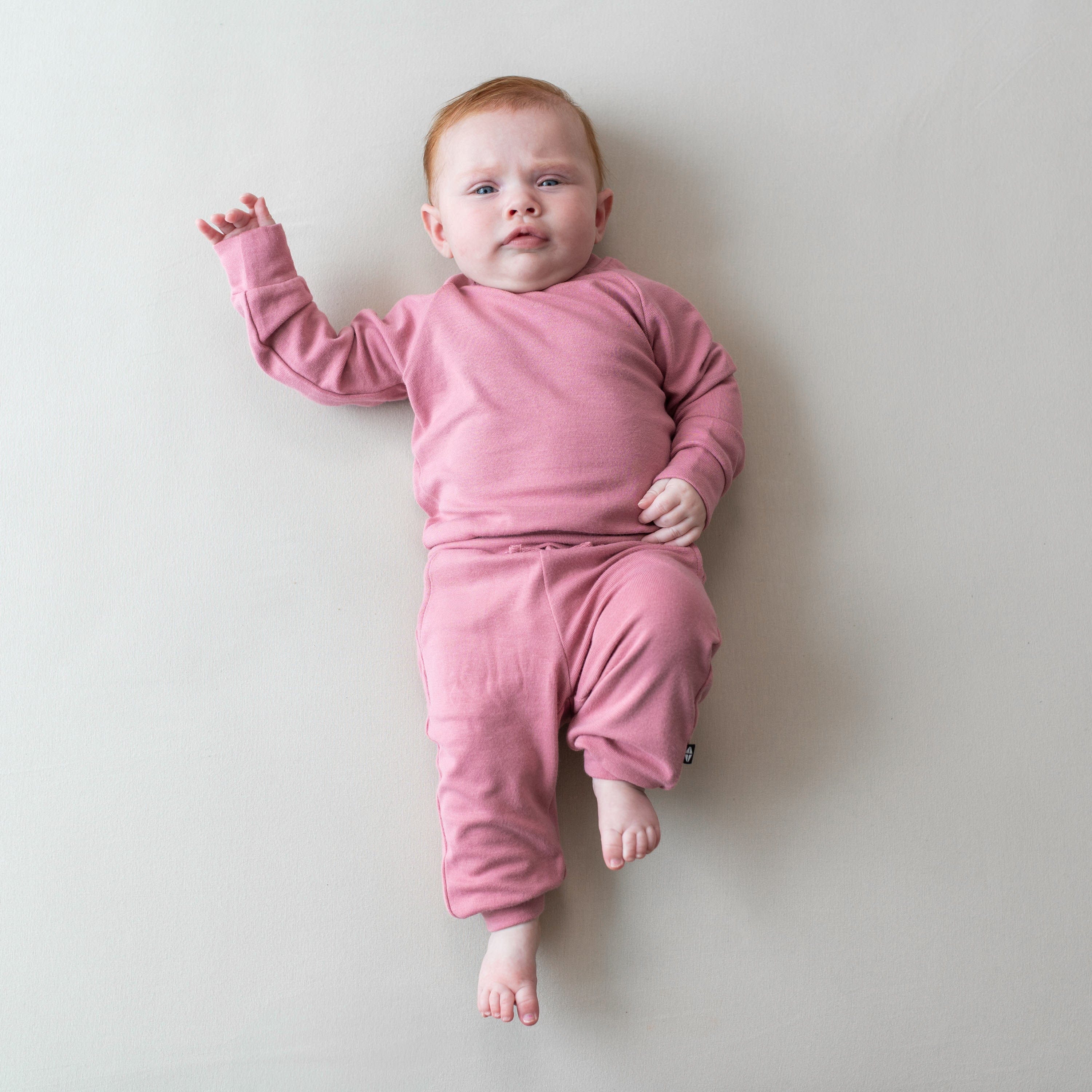 Baby wearing Pink Bamboo Jersey Jogger Set in Apple Blossom