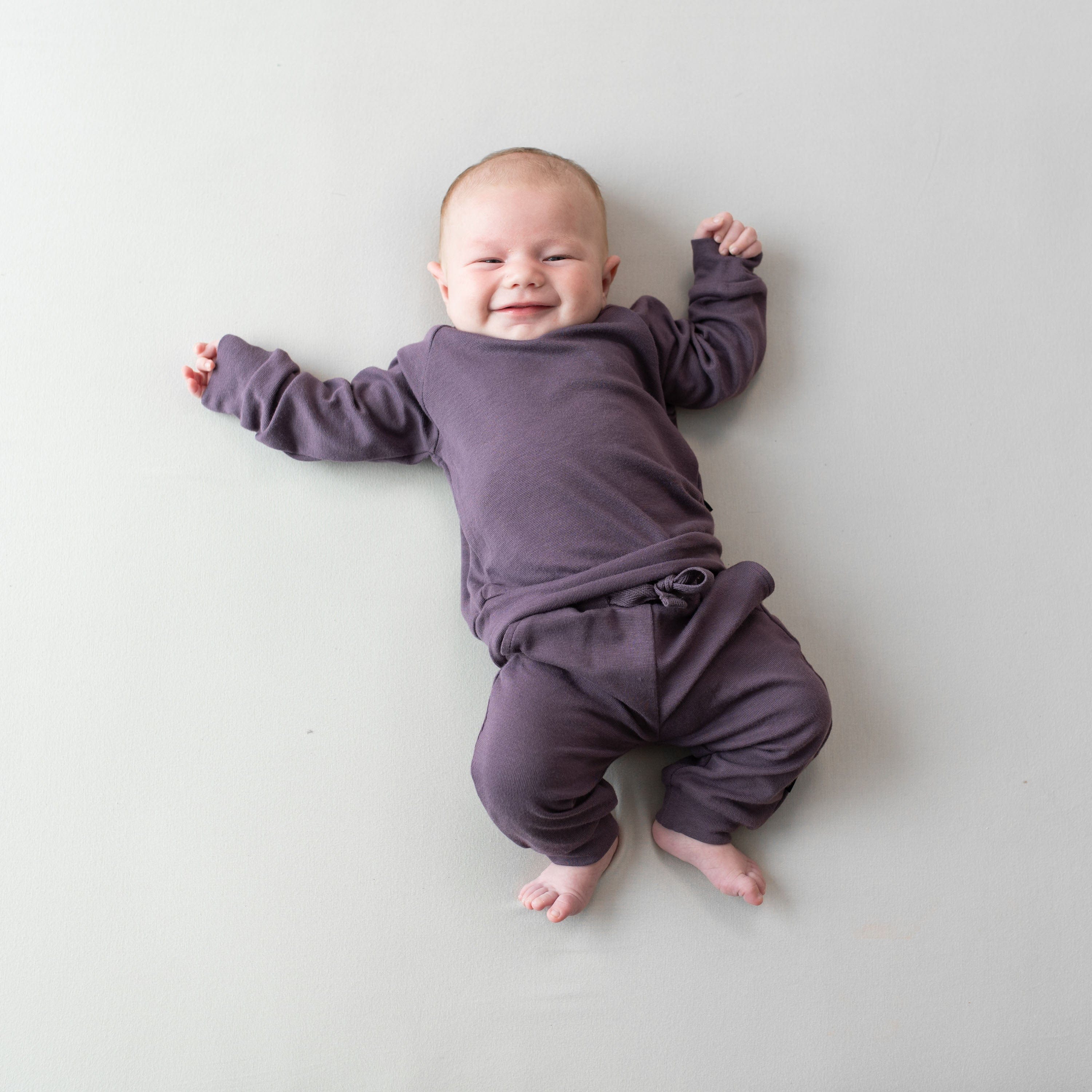 Infant wearing Bamboo Jersey purple Jogger Set in Currant