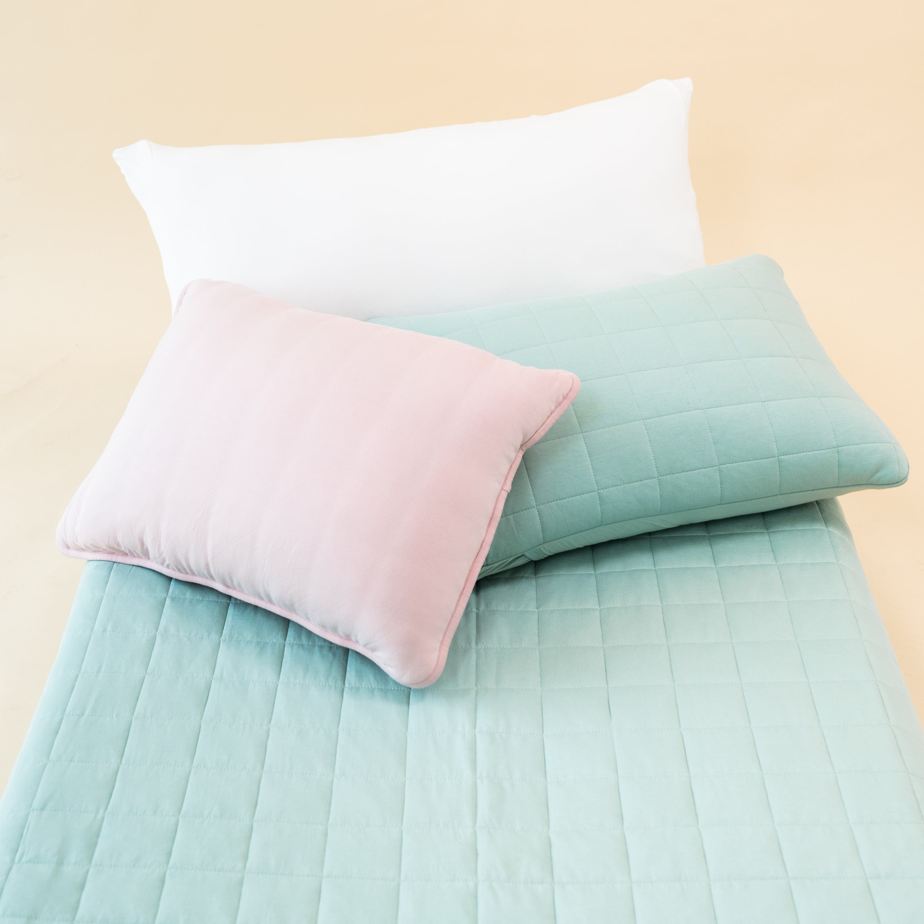 Bed made with Kyte Baby King Quilted Pillowcases and quilt