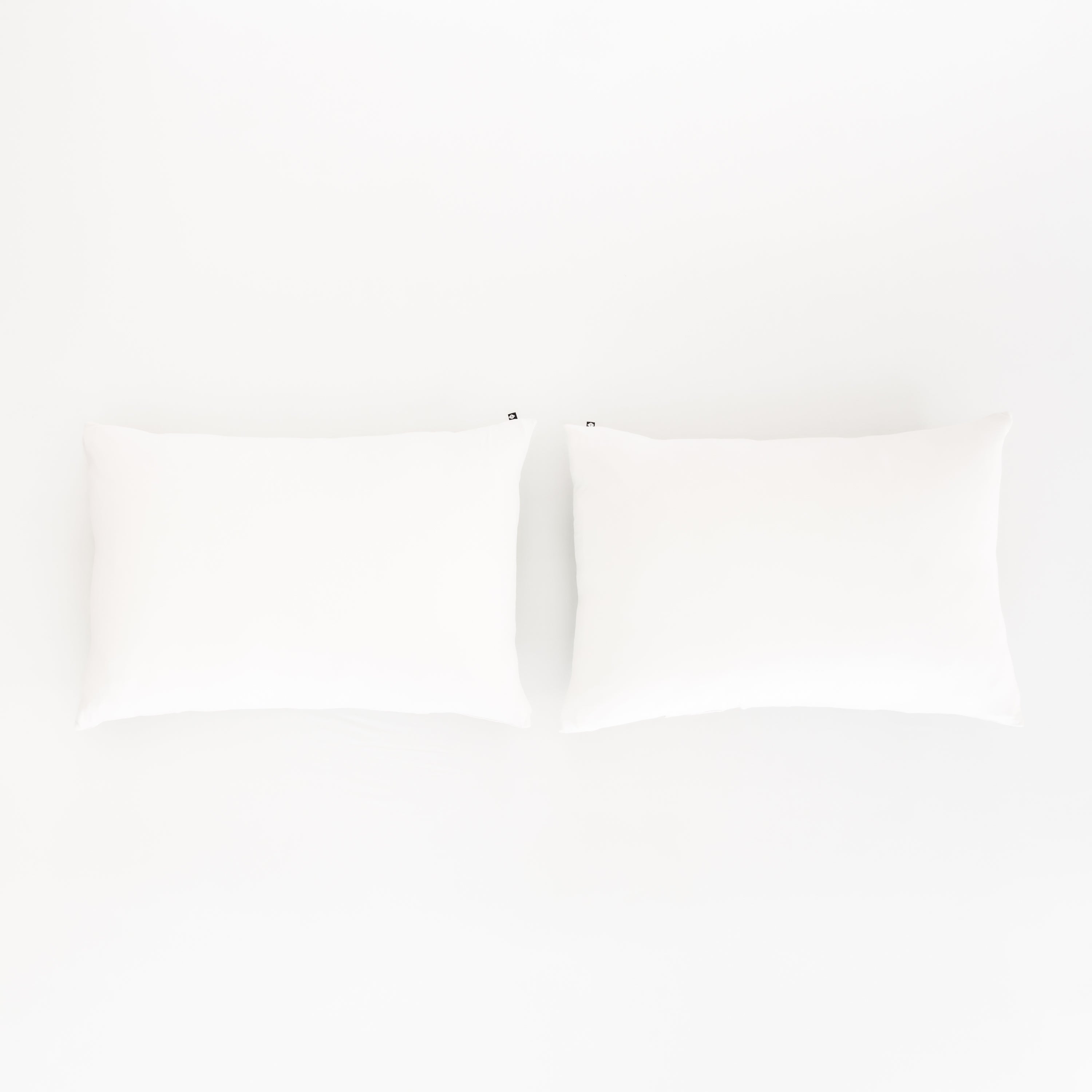 Bed Made with Kyte Baby Fitted Sheet with Pillowcases in Cloud