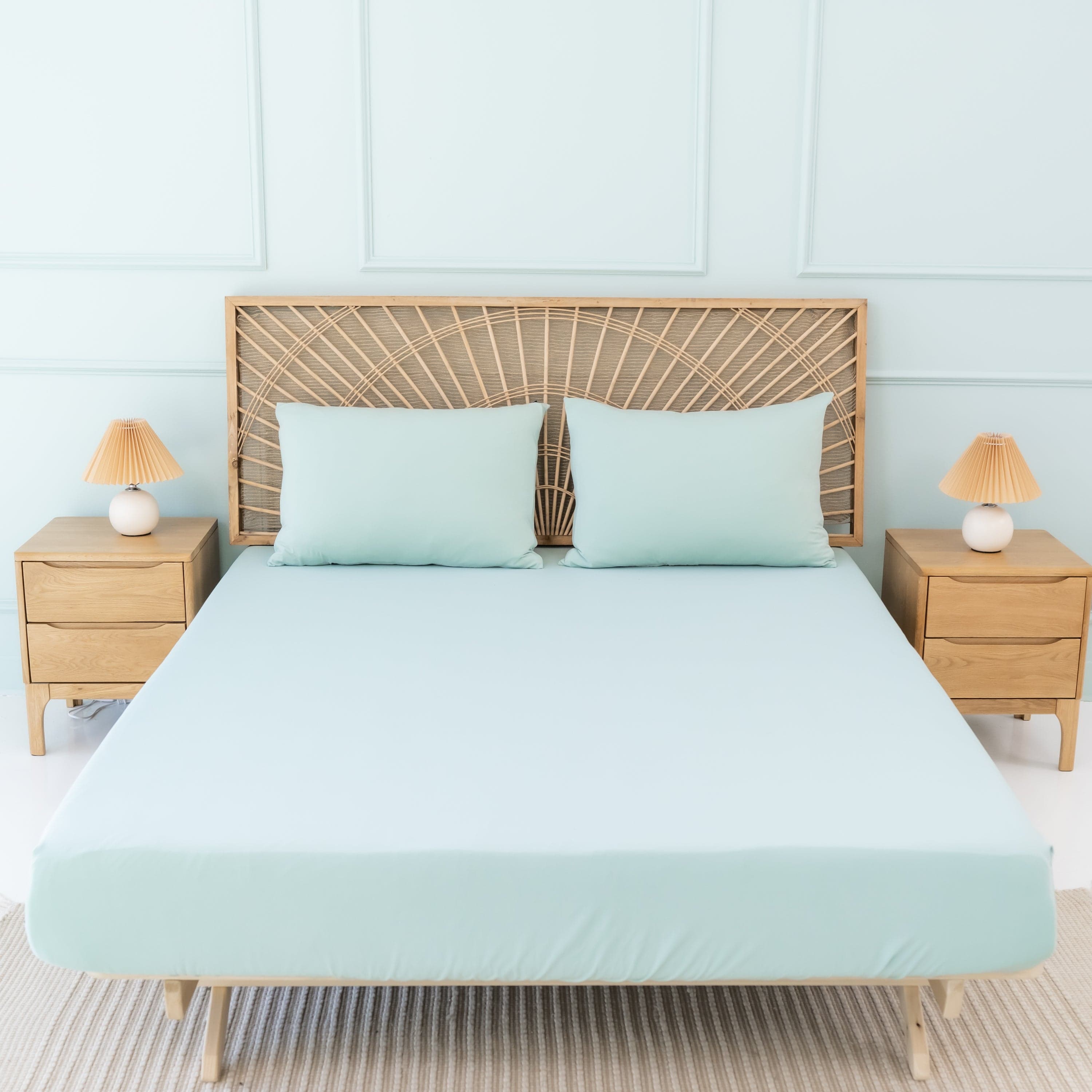 Bed Made with Kyte Baby Fitted Sheet with Pillowcases in Sage green