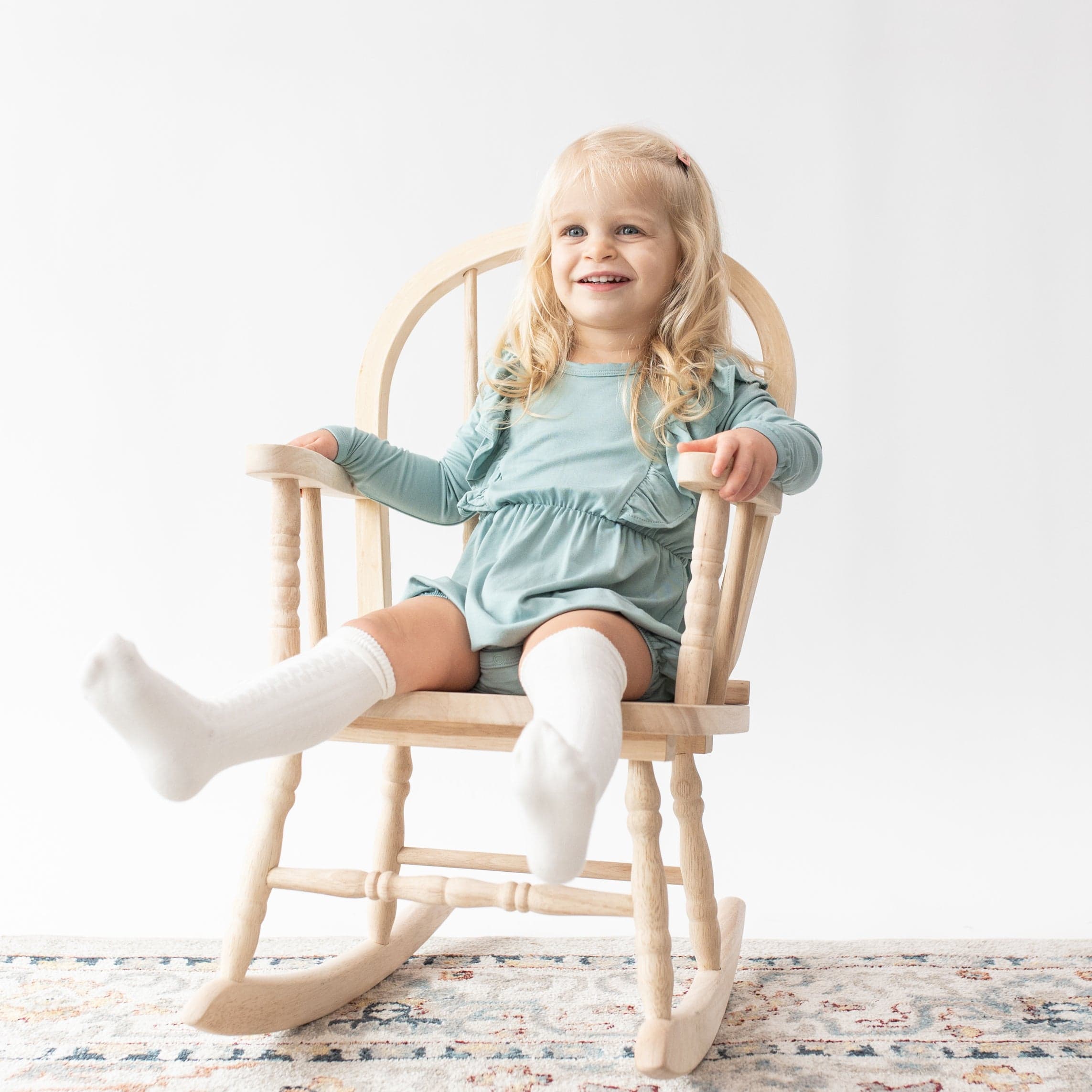 Toddler wearing Kyte Baby cable knit Knee High Socks in Cloud