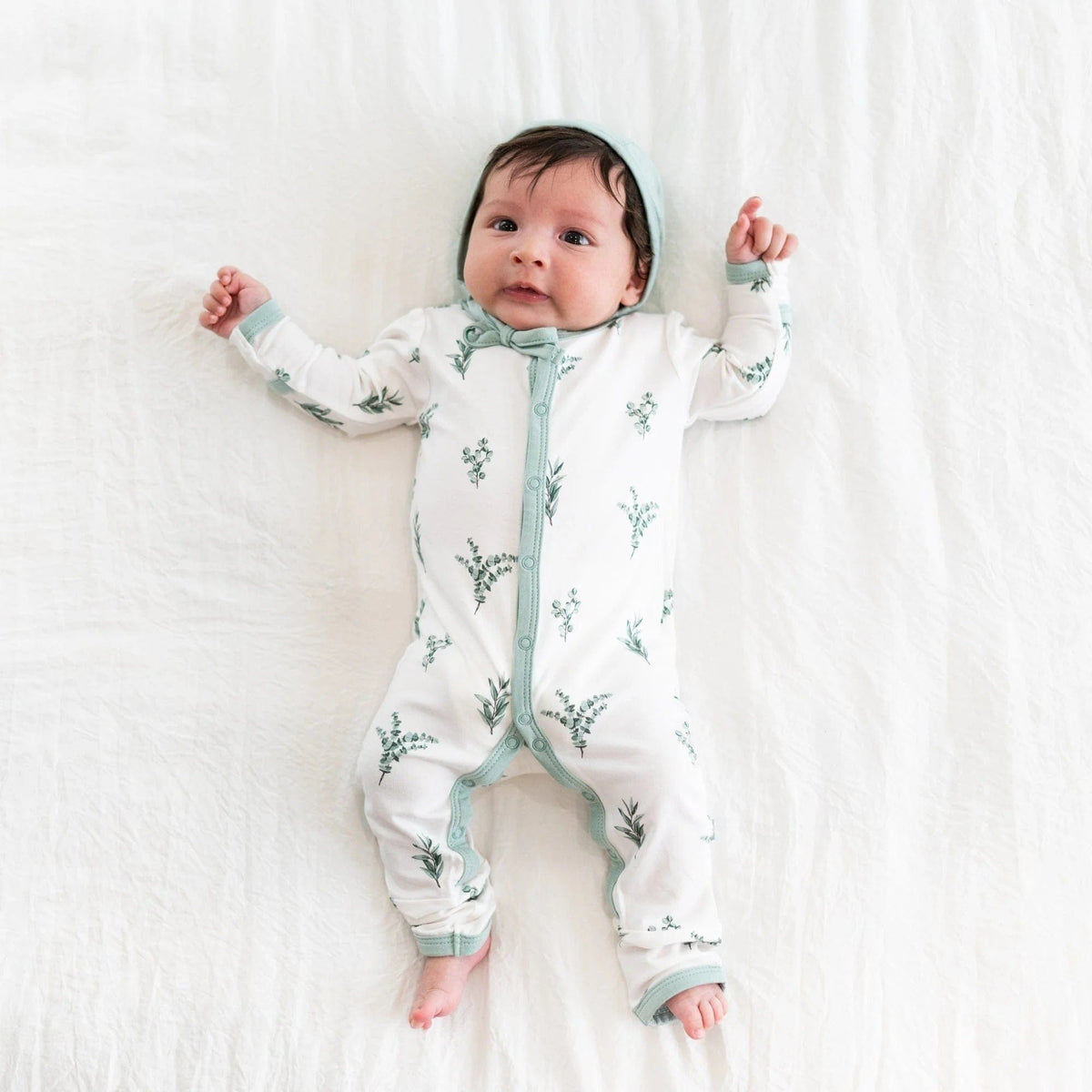 Newborn wearing Bonnet in Sage and a Romper in Eucalyptus
