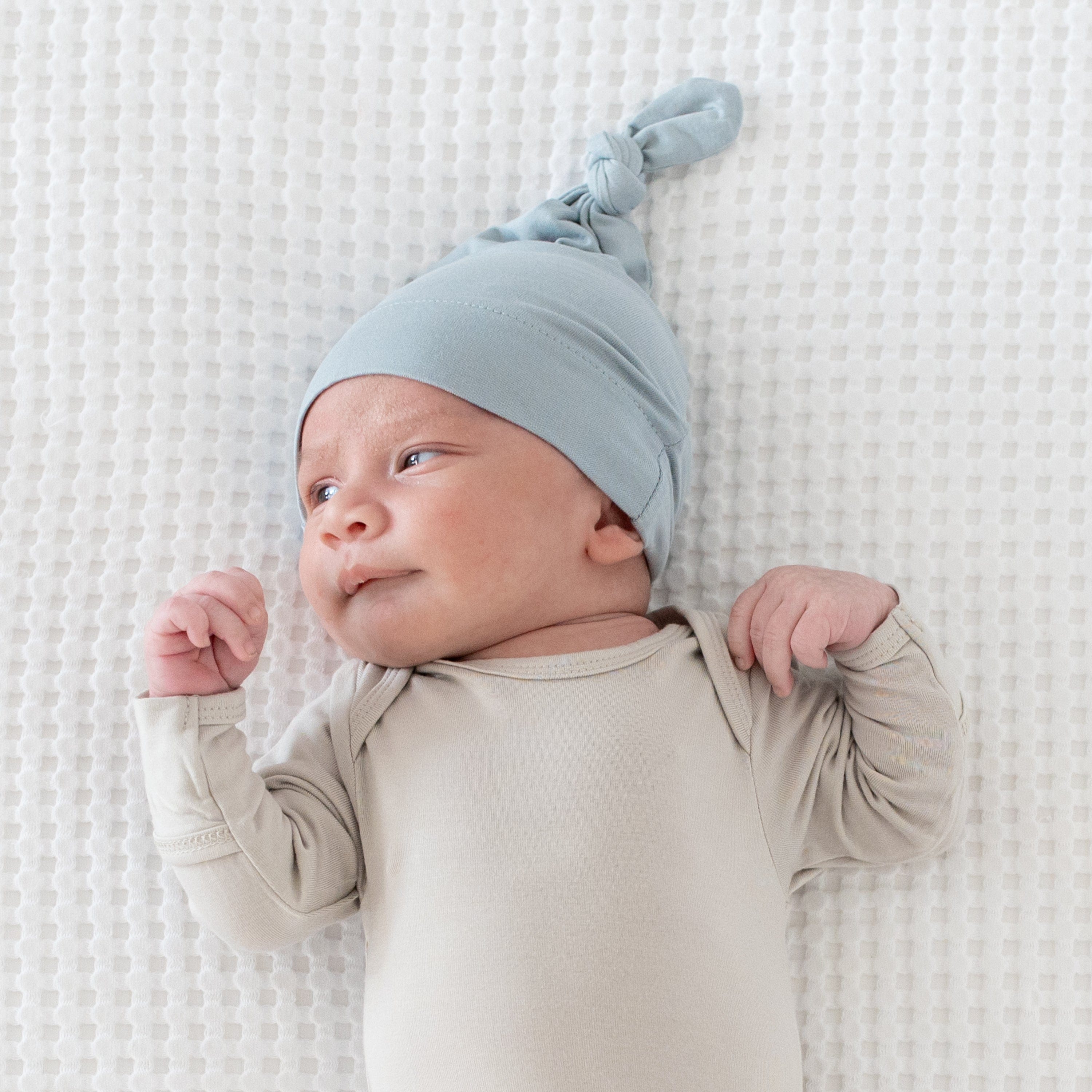 Infant wearing bamboo Kyte Baby Knotted Cap in Fog