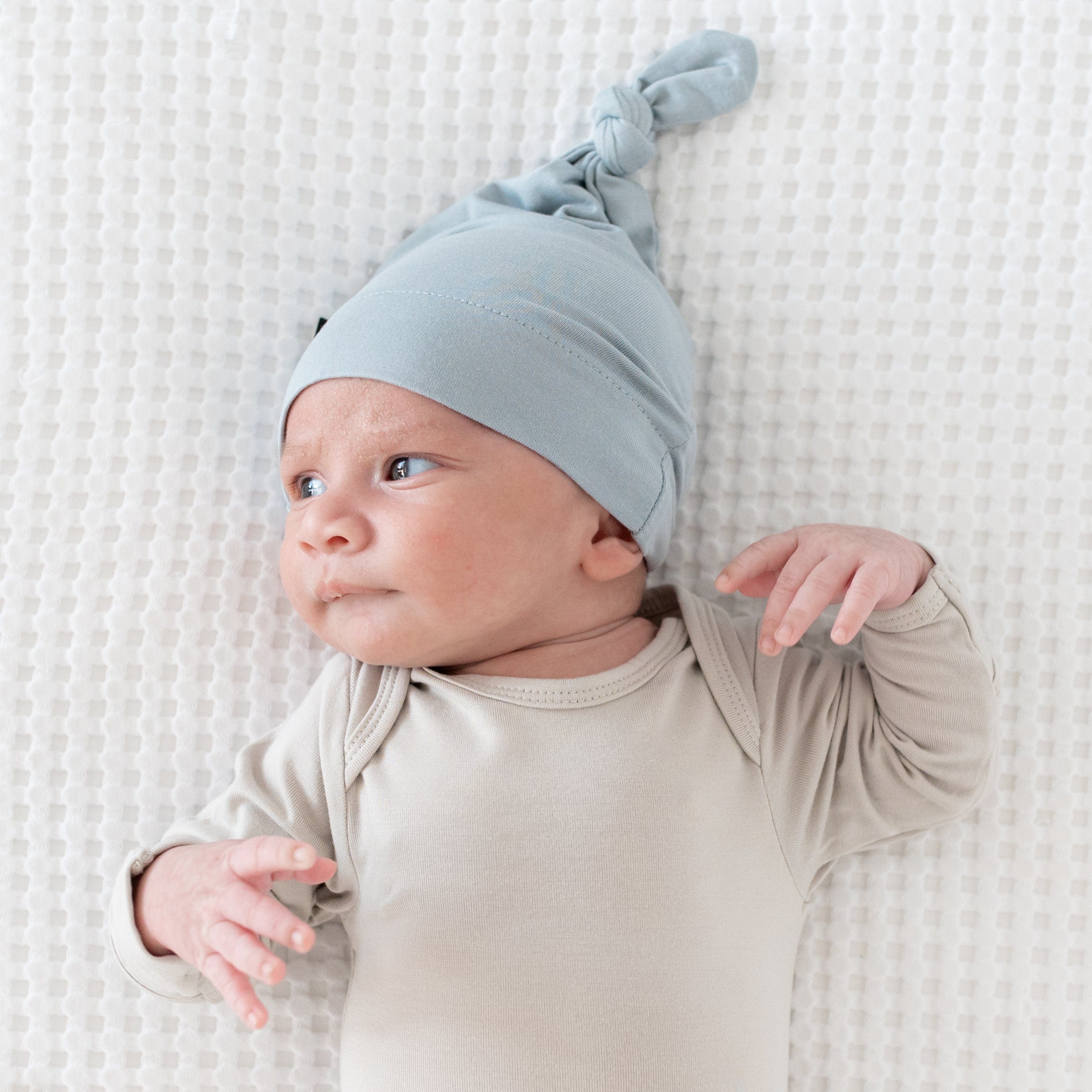 Newborn wearing a Knotted Cap in Fog and a Long Sleeve Bodysuit in Oat