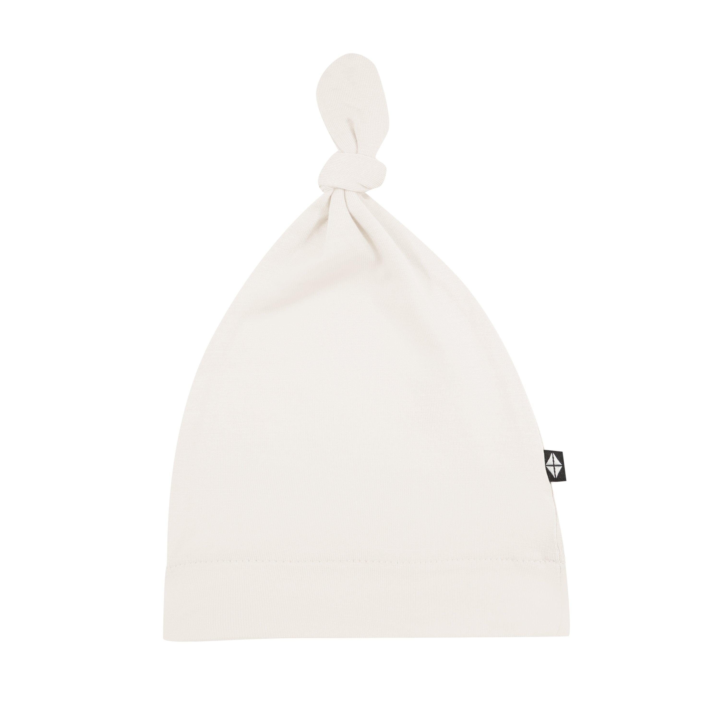 Flat lay of Kyte Baby Knotted Cap in Oat