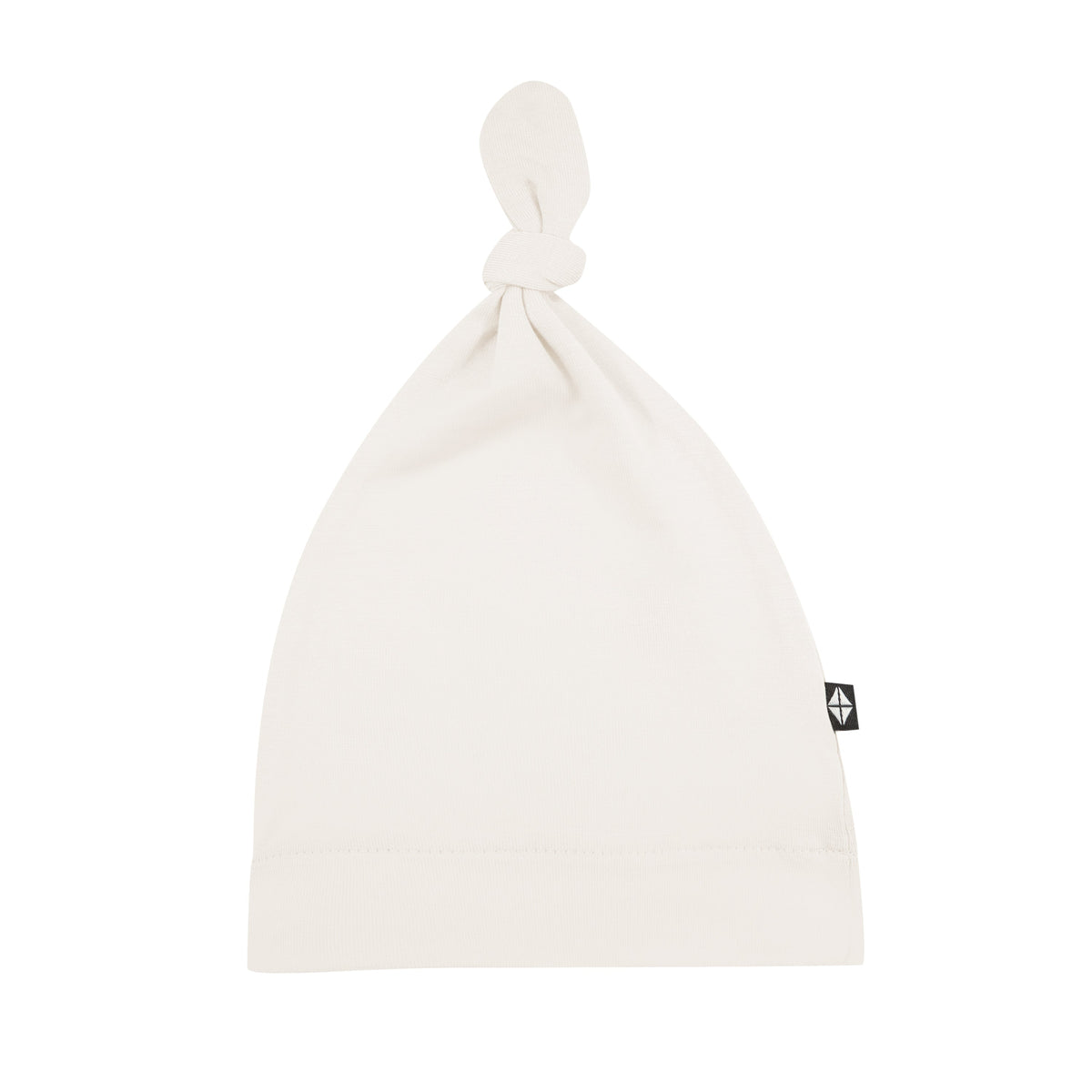 Flat lay of Kyte Baby Knotted Cap in Oat