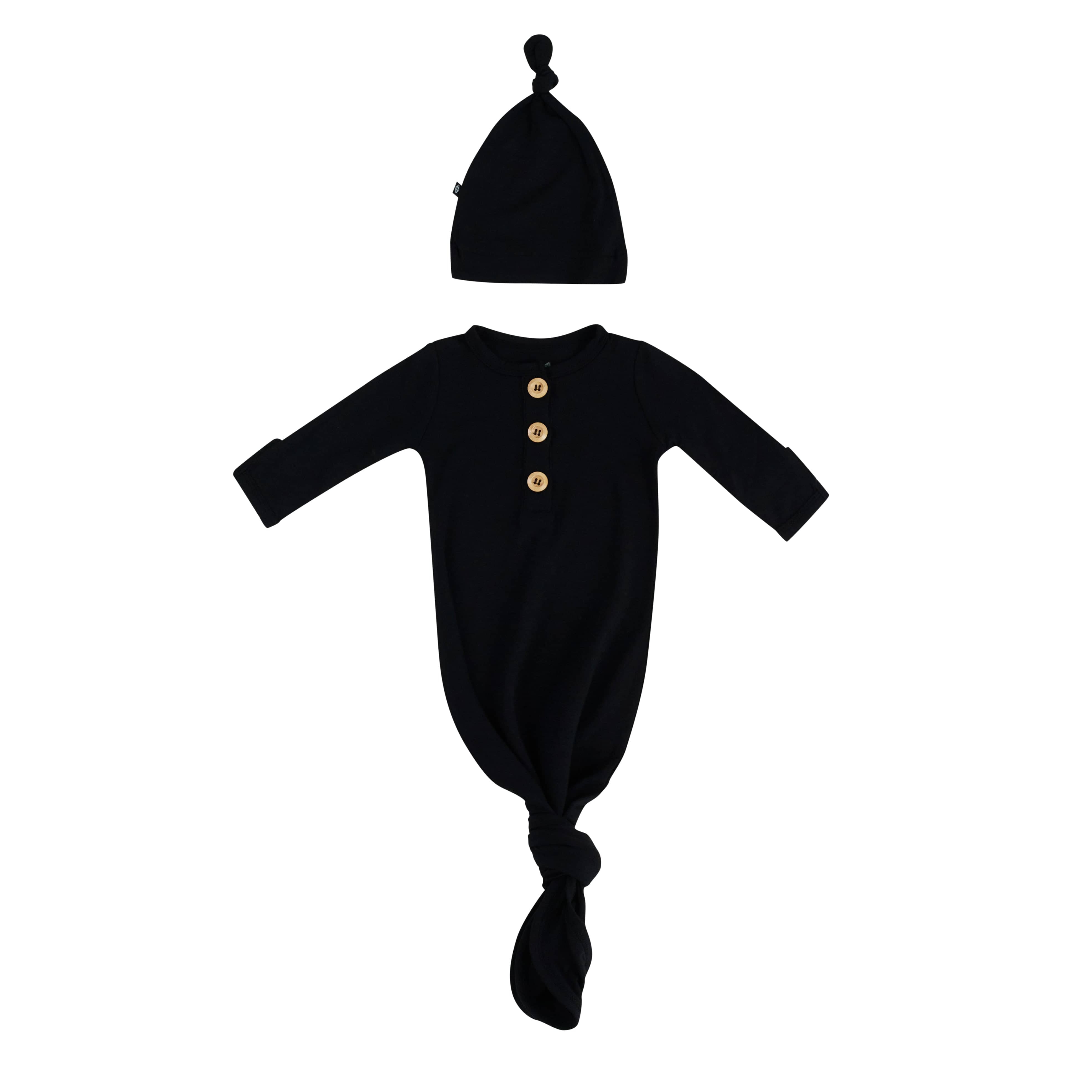Flat lay of Kyte Baby Knotted Gown with Hat Set in Midnight